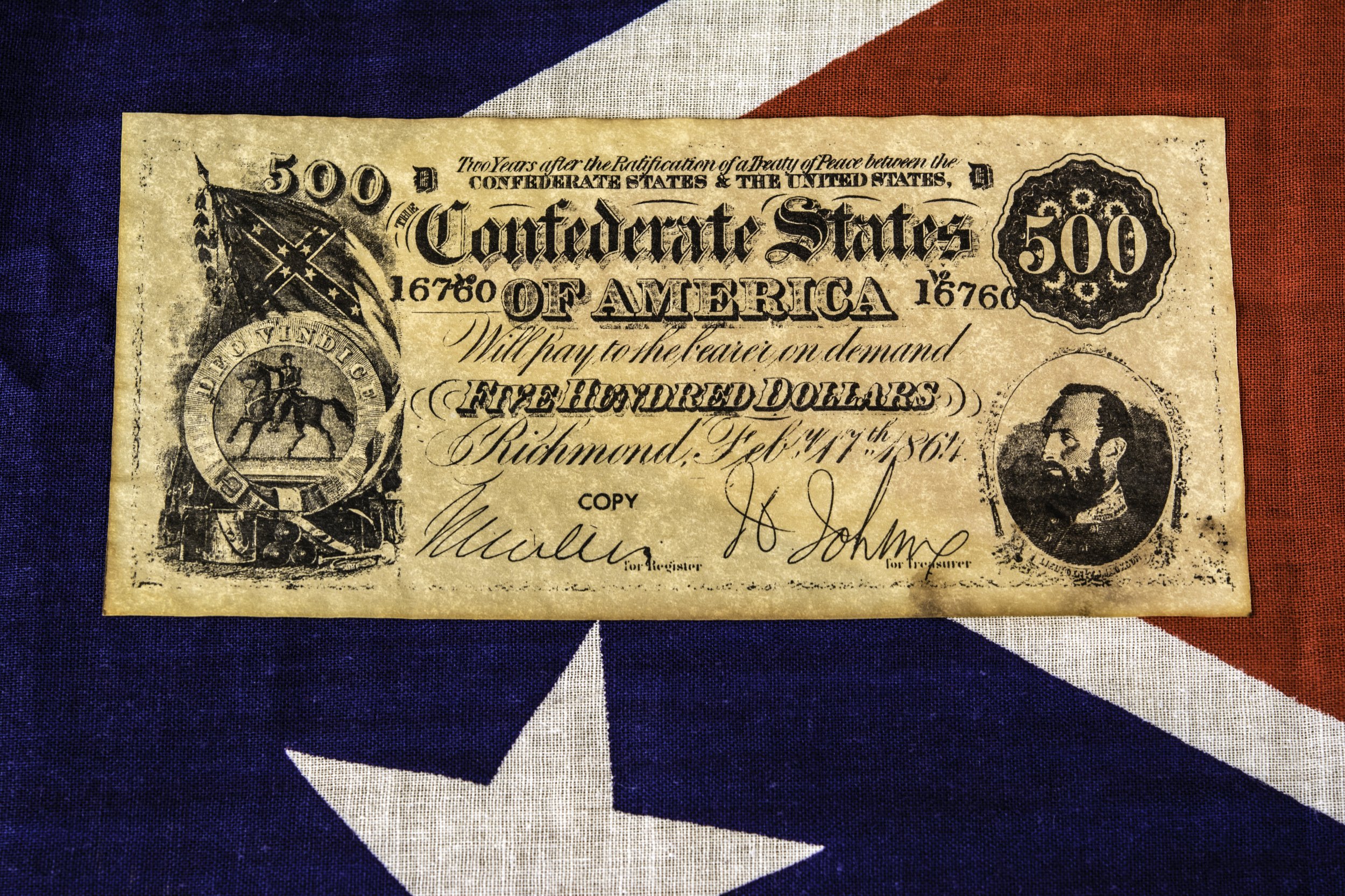 Confederate dollar bill on Confederate flag