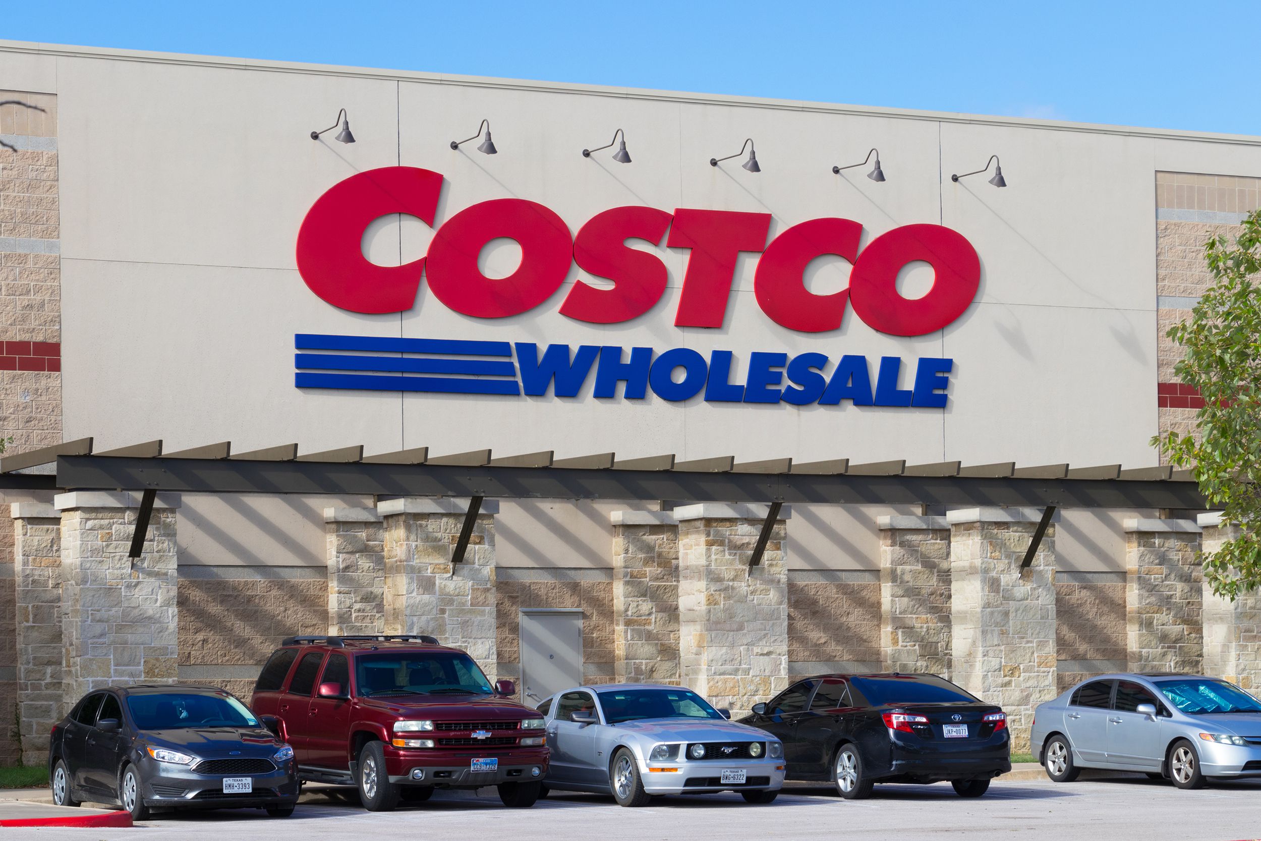 Row of parked vehicles under the Costco Wholesale sign.