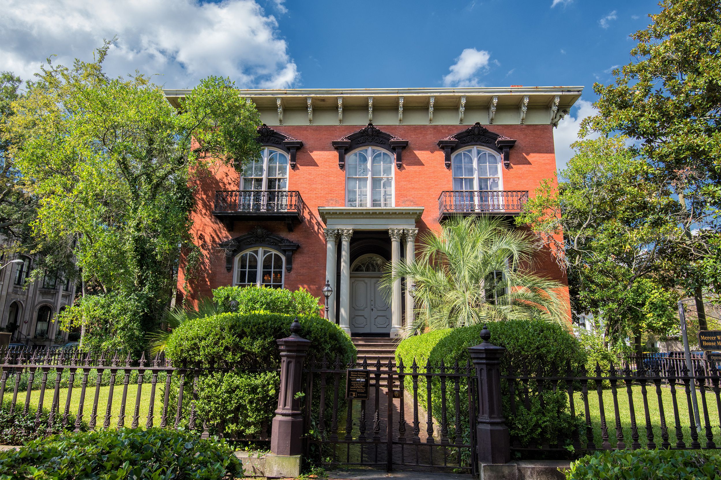Front exterior of the Mercer House in Savannah, Georgia, as seen from front gate on a bright sunny day