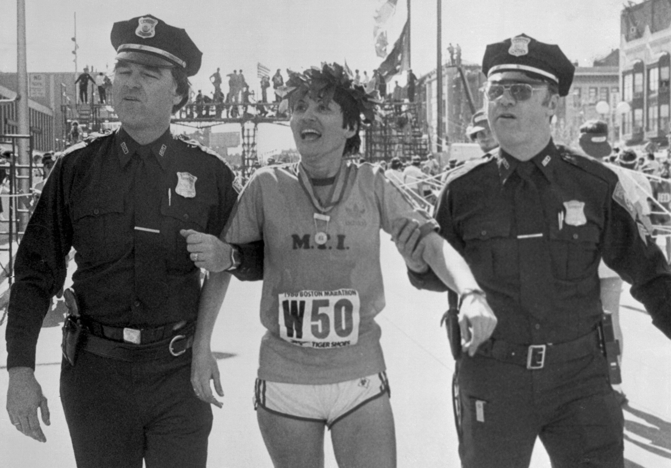 Rosie Ruiz of New York, is supported by two Boston police officers, as she makes her way to the dressing room after winning the 26 mile, 385 yard, 84th BAA Marathon.