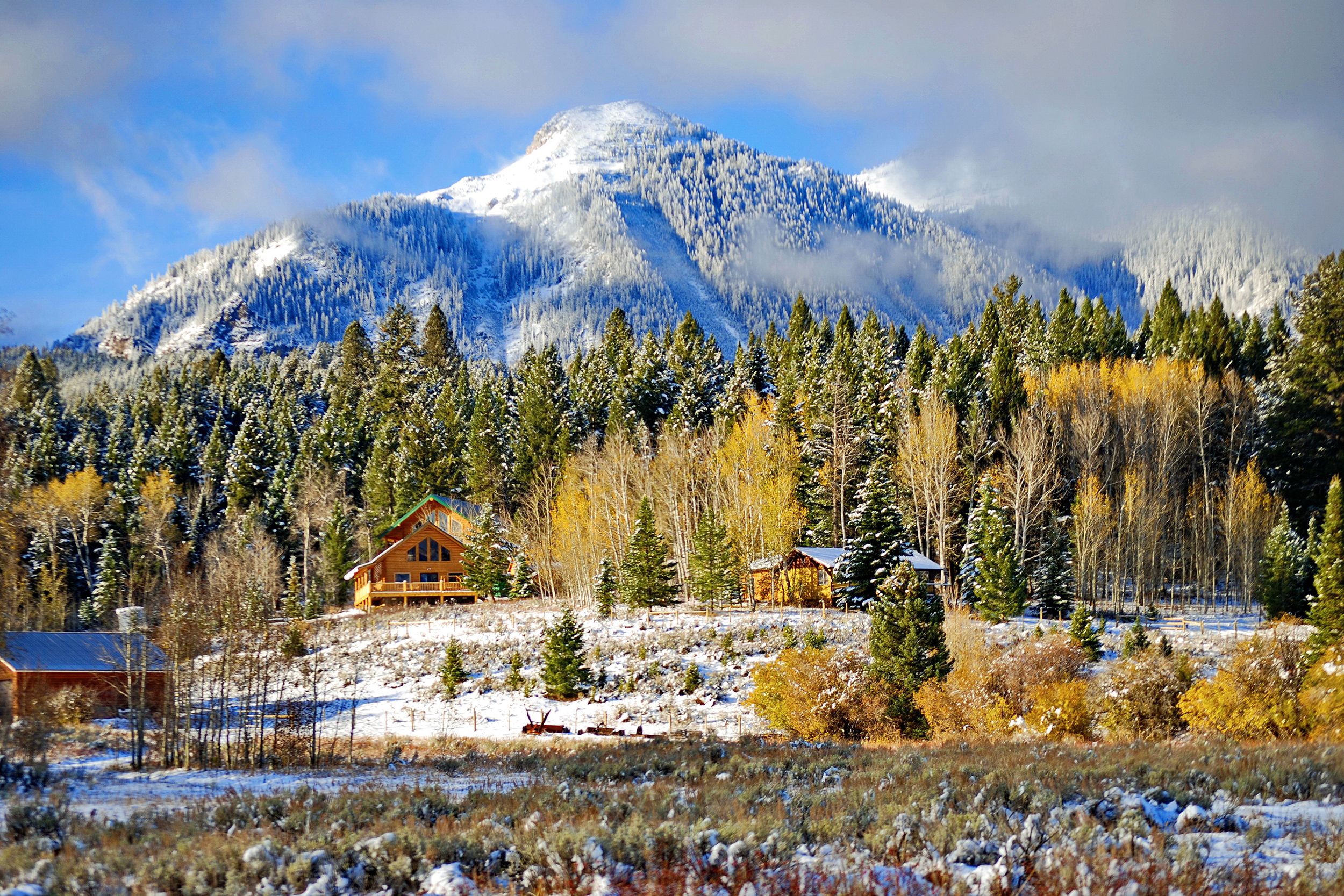 Snowy Island Park, ID, with cabins, forest and mountain