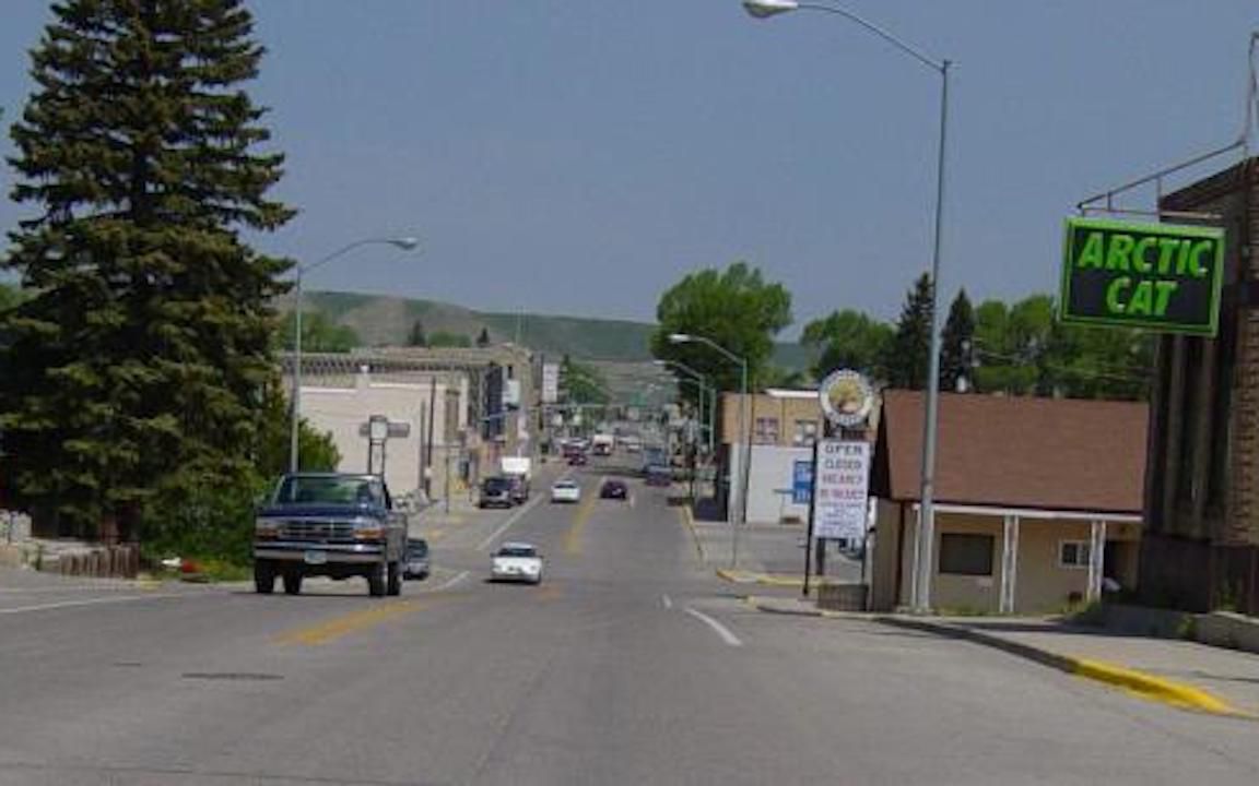 View of road going through small town of Kemmerer, Wyoming in summer on a clear day