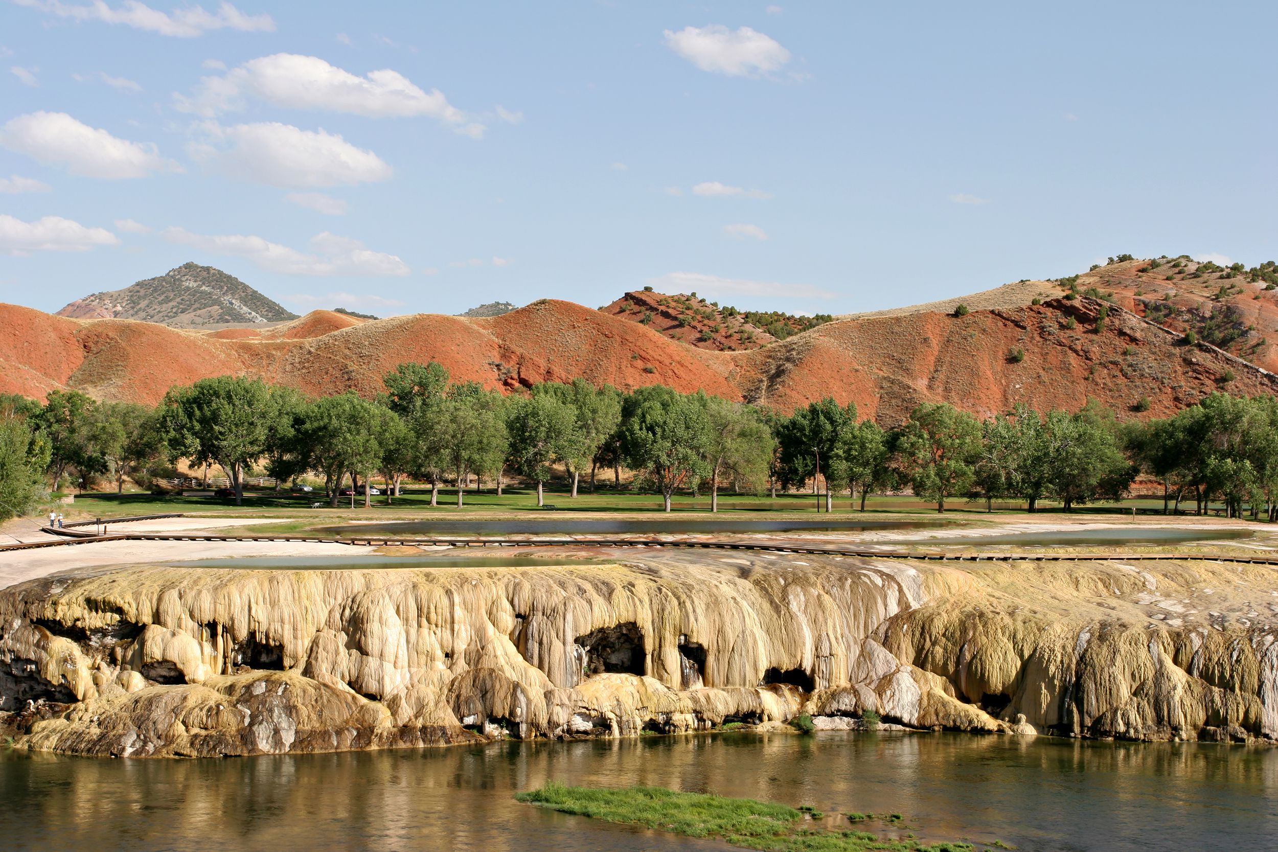 View from pond onto hills and trees in summer in Thermopolis, WY