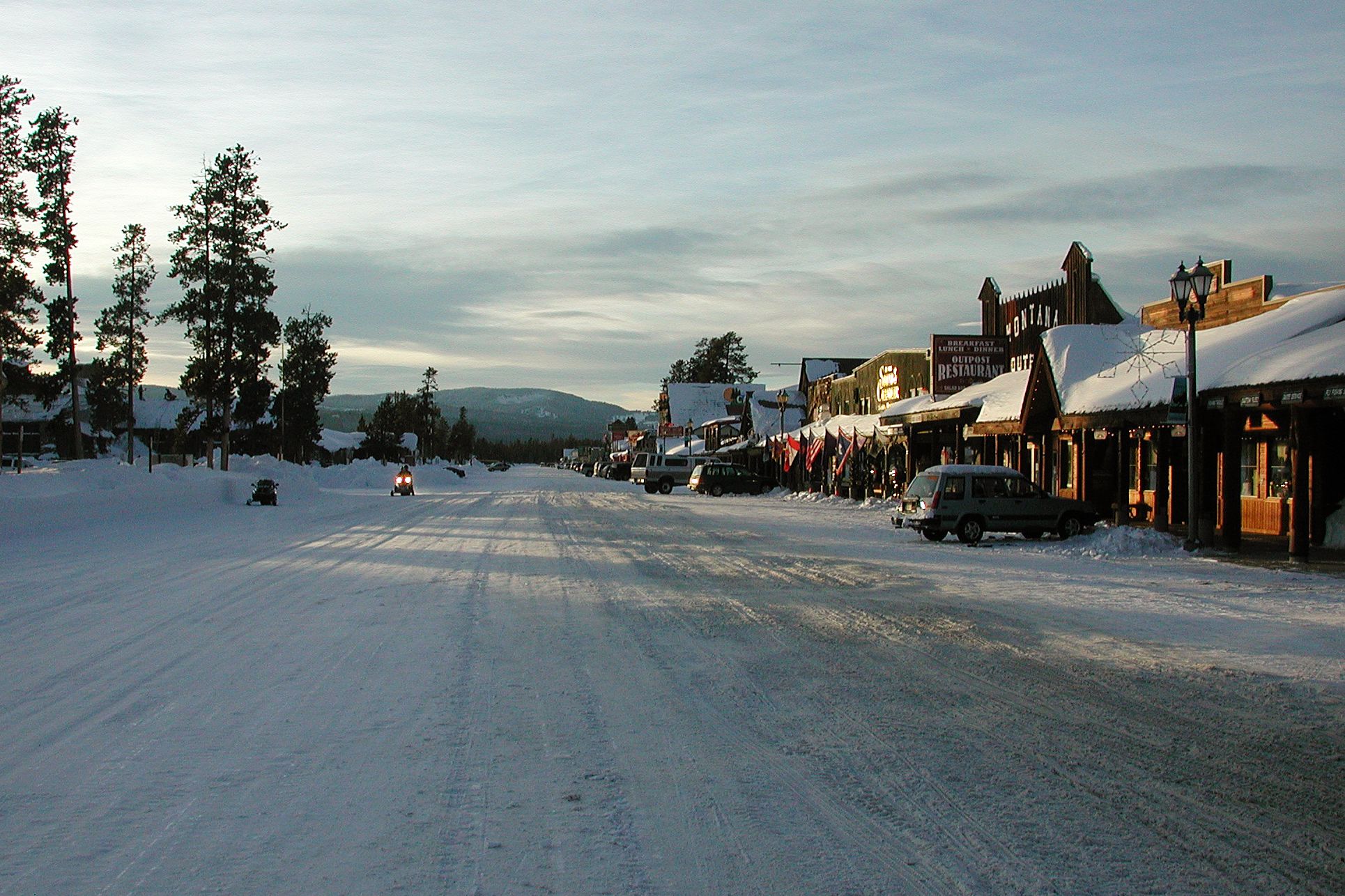 Person riding snow mobile on street in West Yellowstone, MT