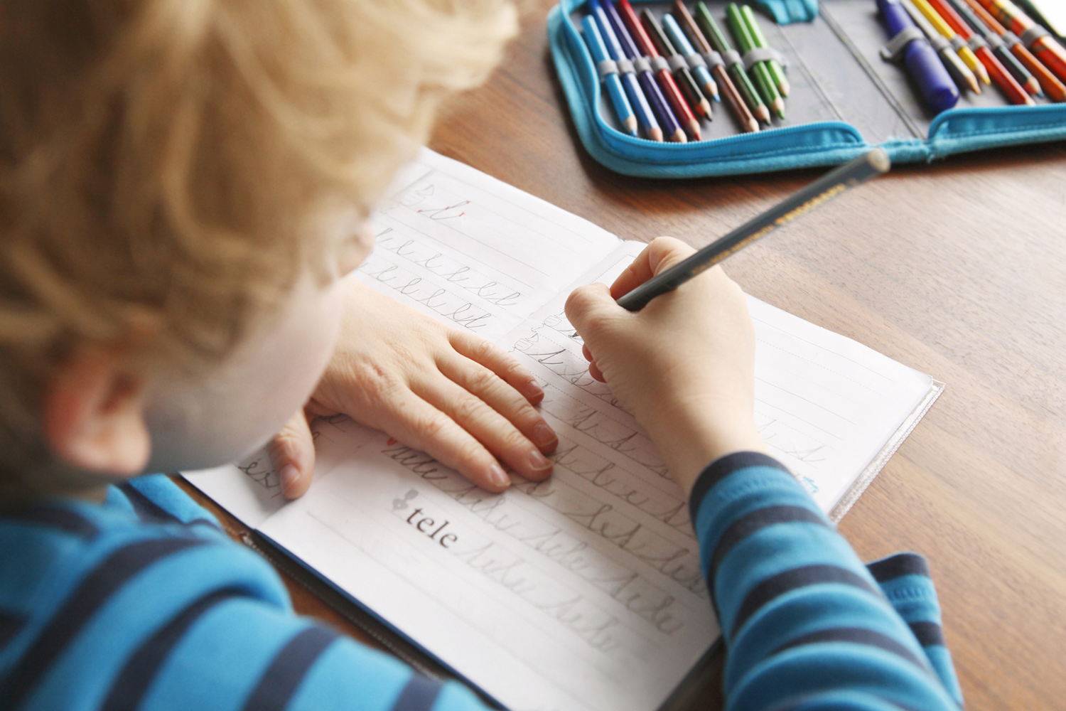 child practicing cursive