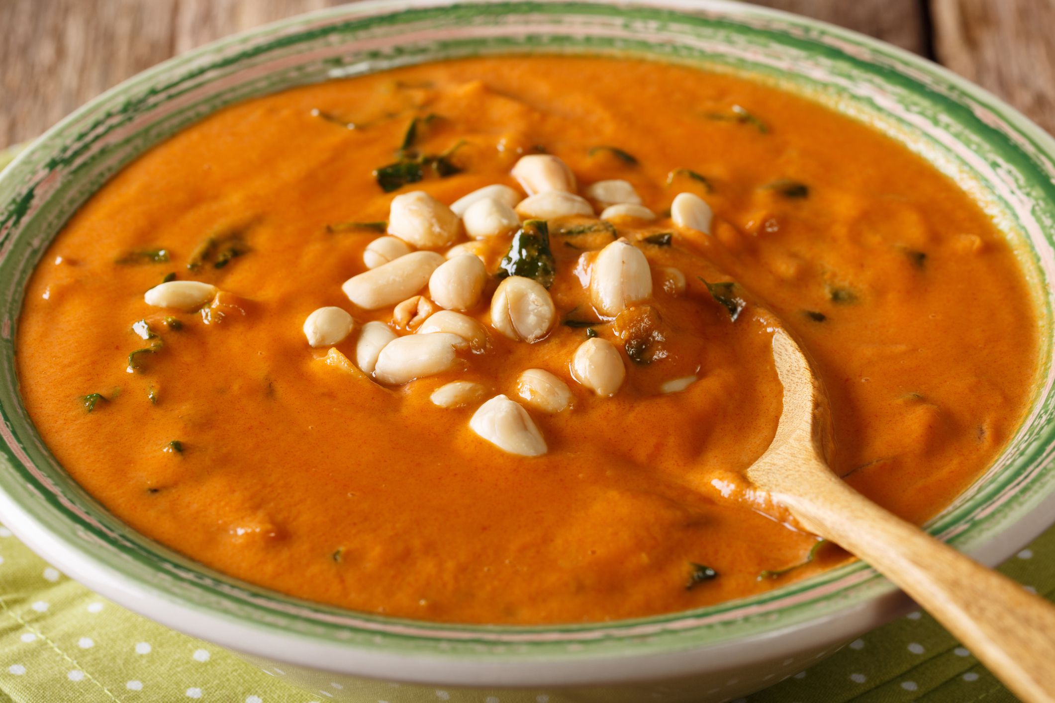 Homemade peanut cream soup close-up on a plate. horizontal