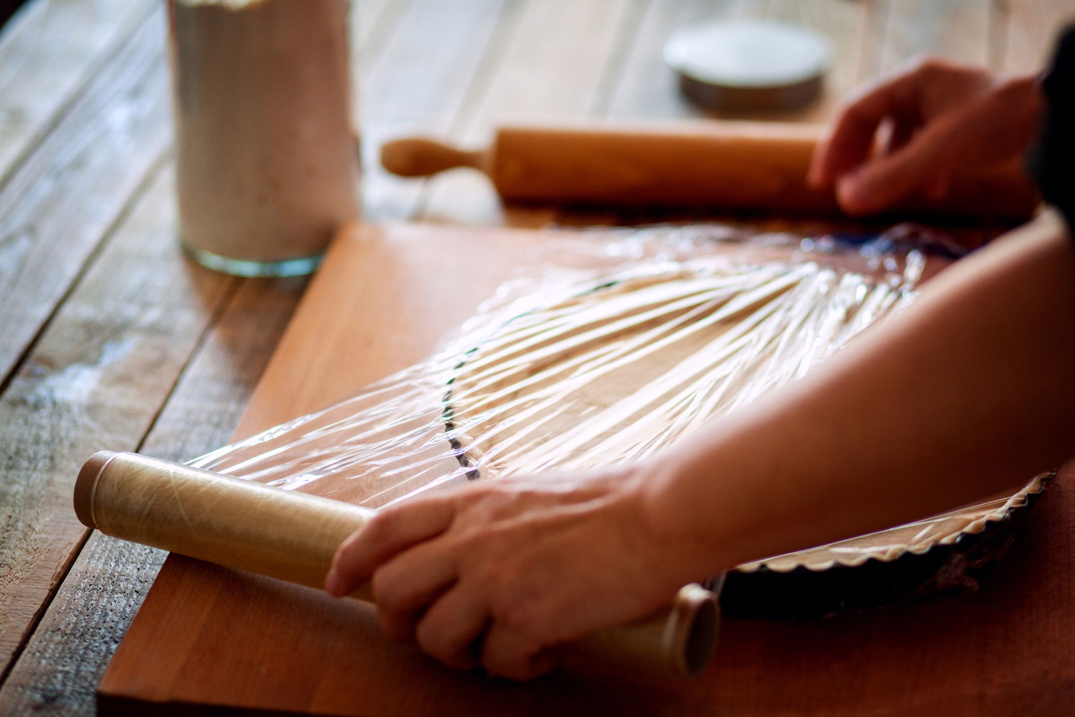 plastic cling wrap being placed over pie