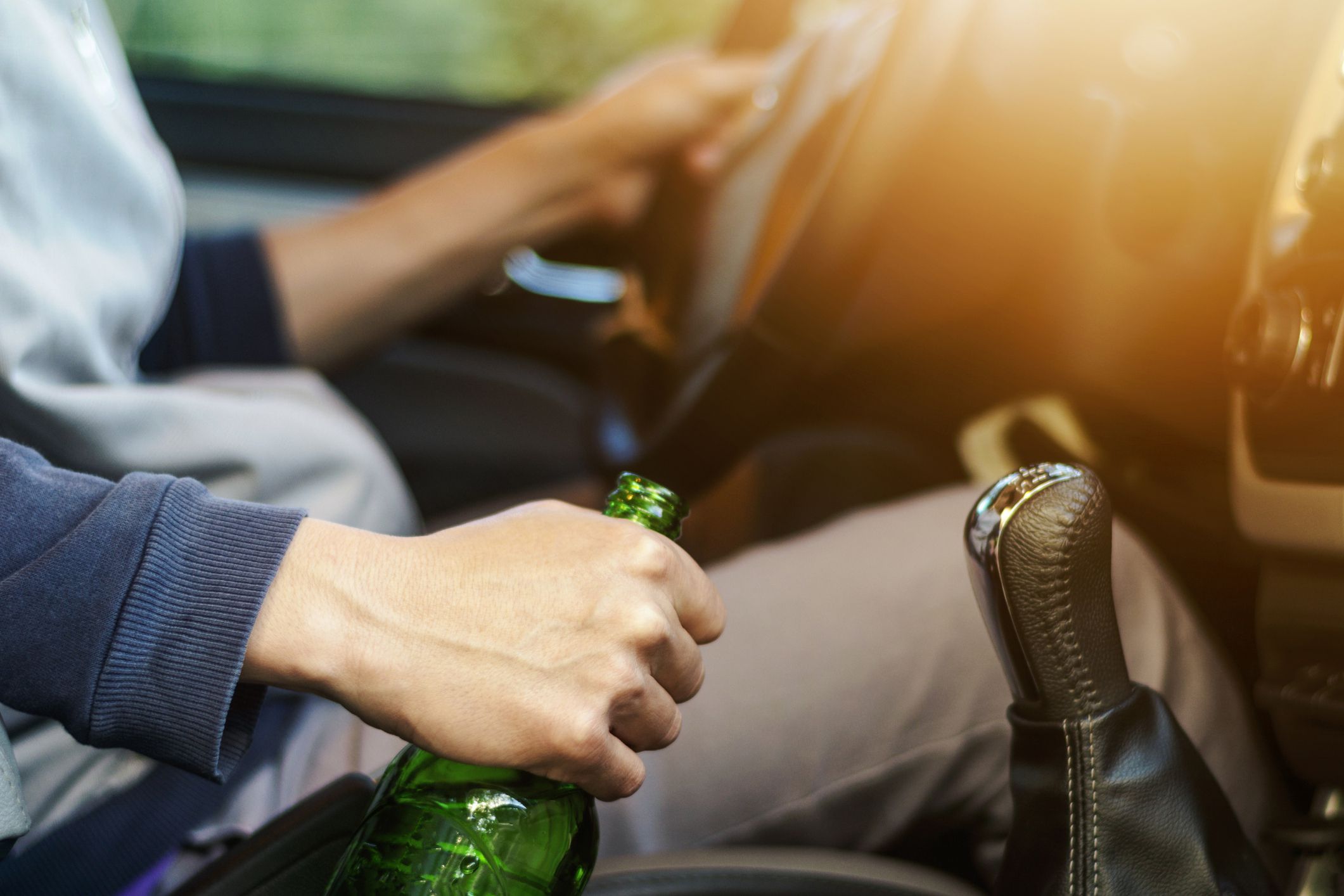close-up of driver holding beer