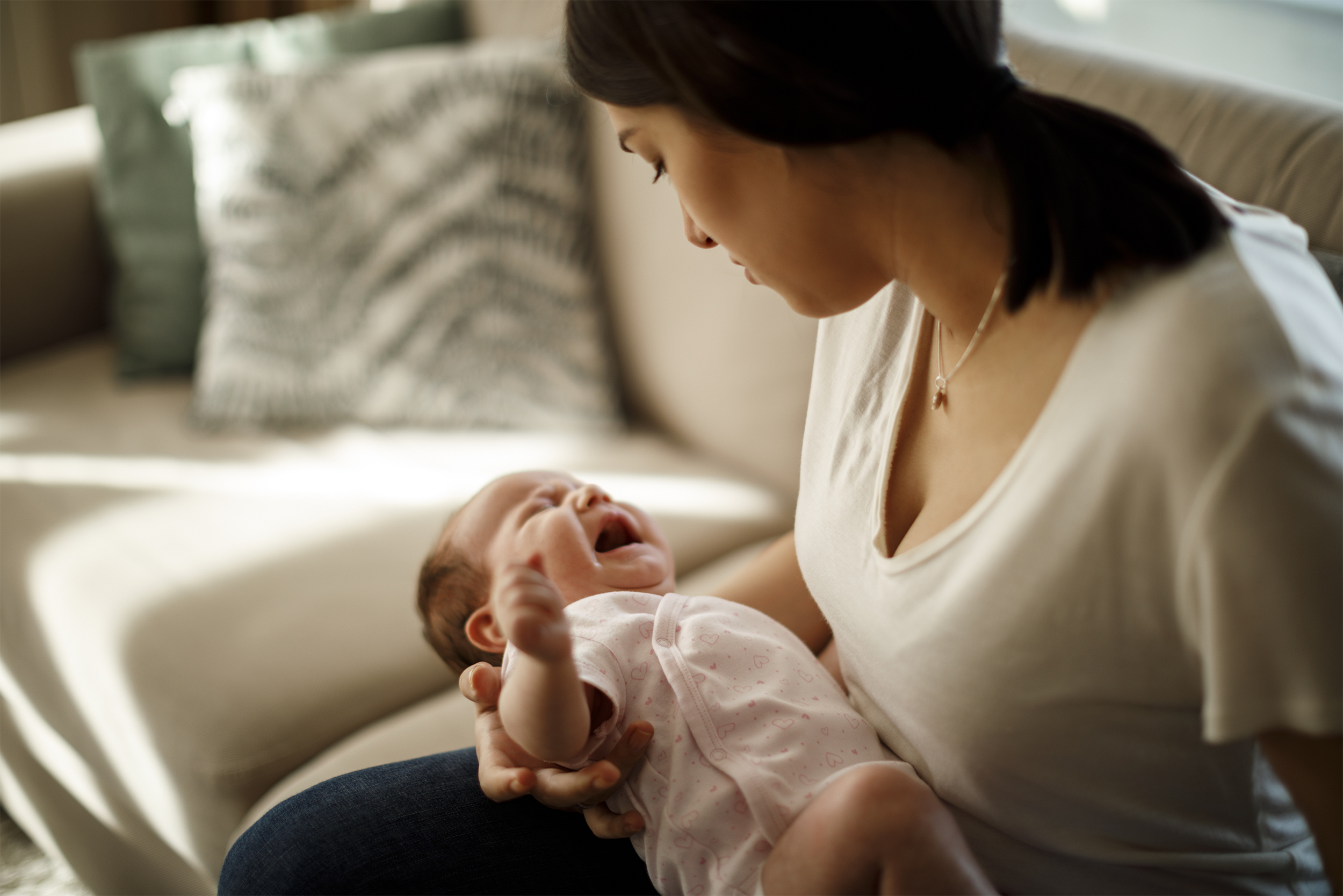 mother holding crying newborn experiencing depression