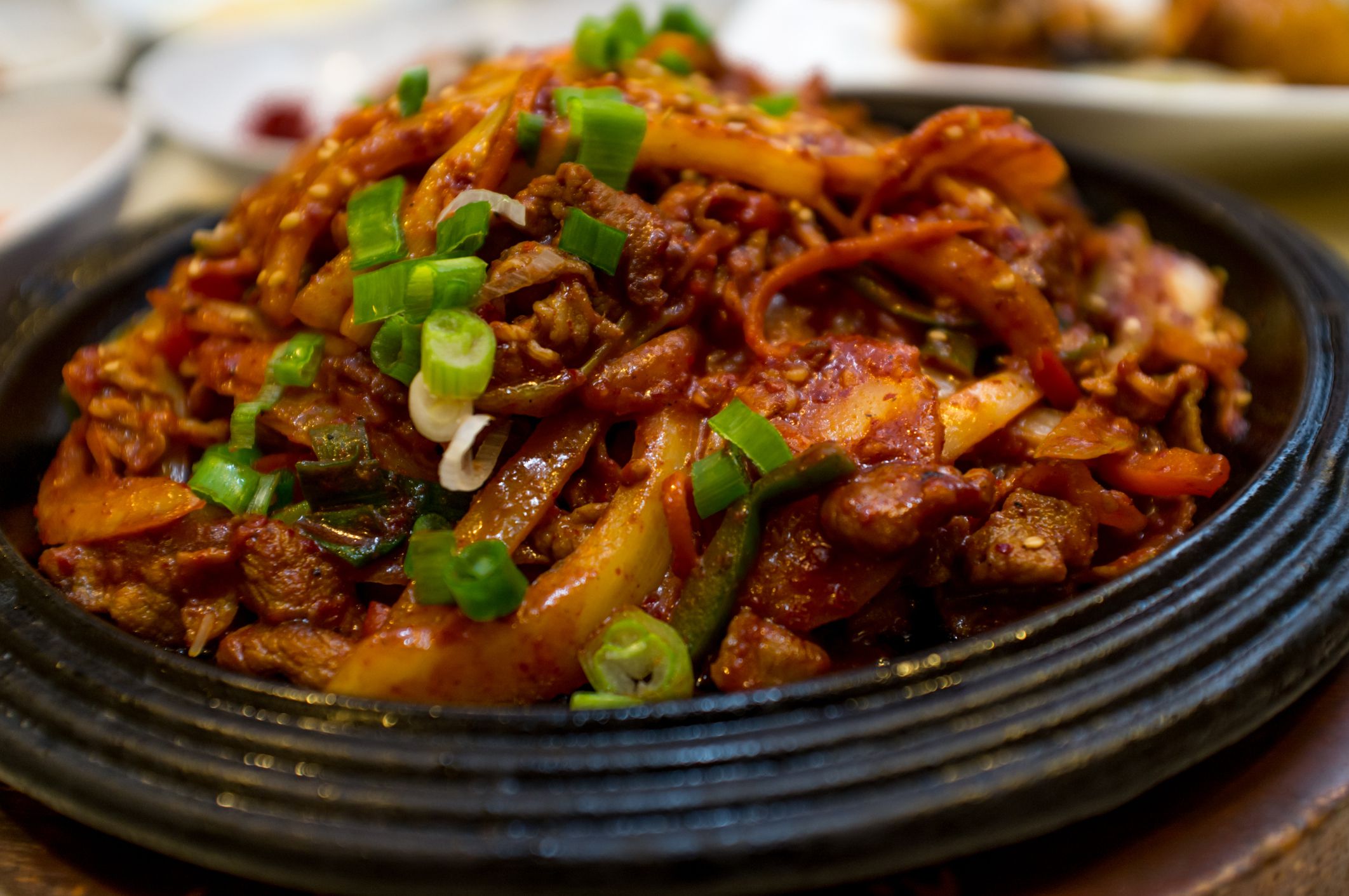 Korean stirfried Jaeyook Bokkeum stir fried pork shoulder with scallions and firm tofu