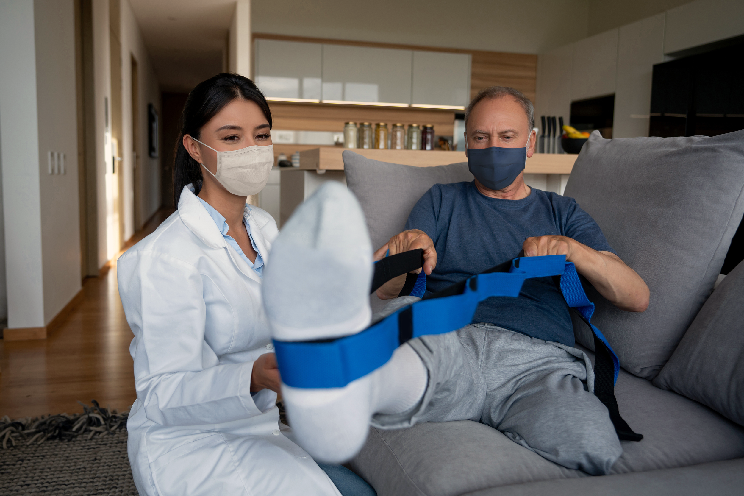 Physical therapist helping a disabled man at home
