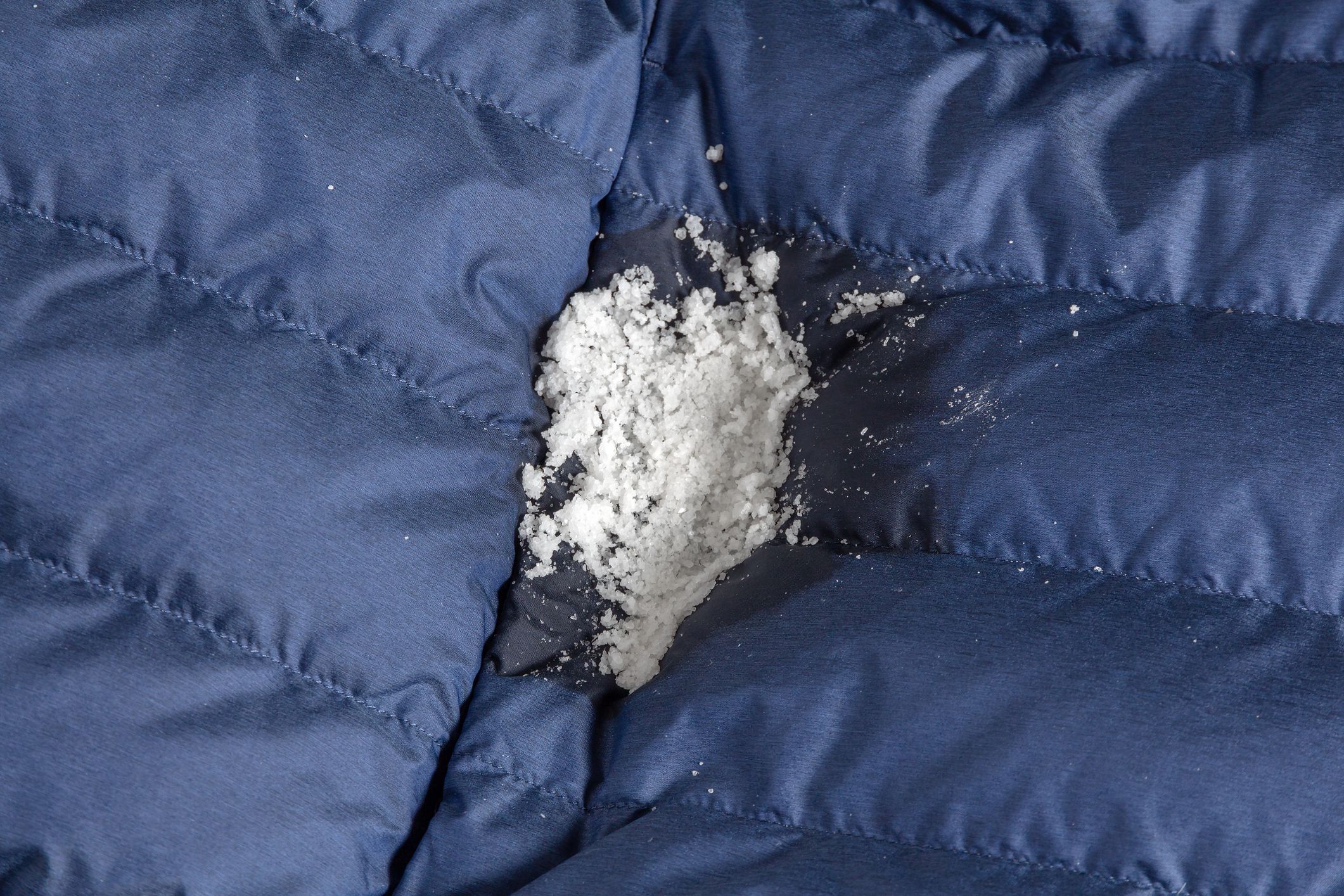 Removing dirt and grease stains from clothes with salt. Down jacket cleaning at home