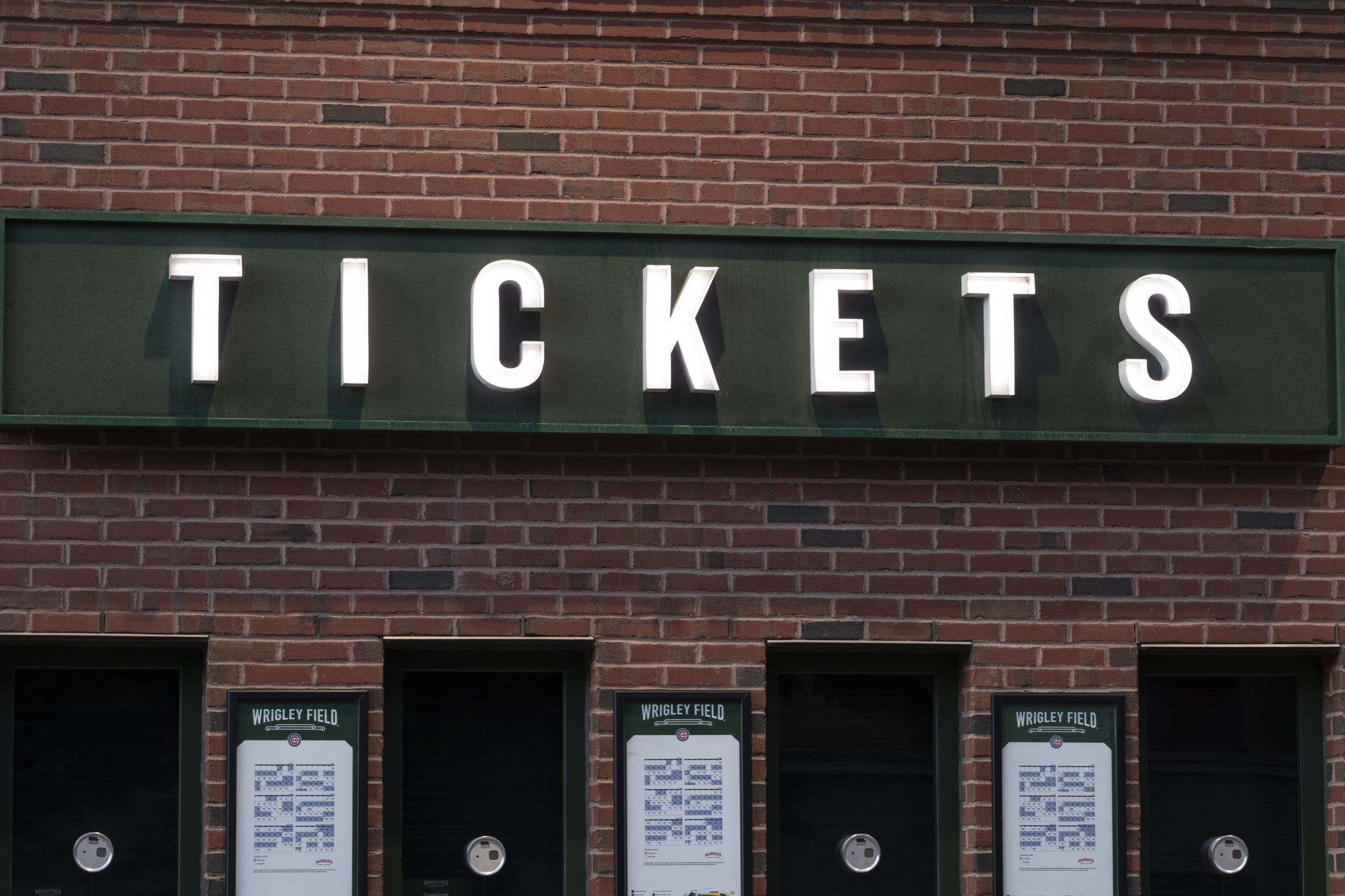 Chicago - Circa May 2021: Wrigley Field Home of the Chicago Cubs ticket office with Cubs schedule posted. Wrigley Field has been home to the Cubs since 1916.