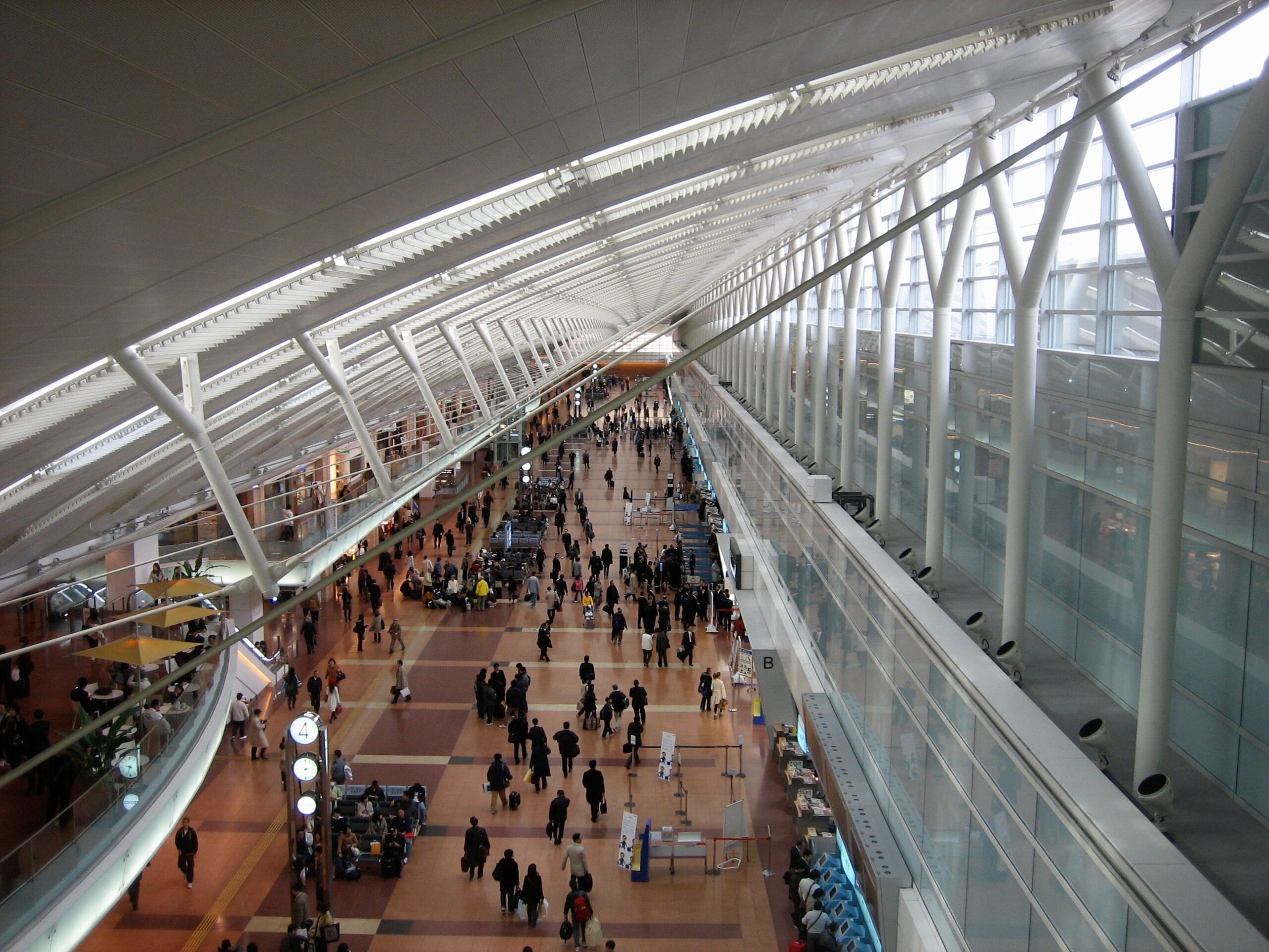 Osaka, Japan - March 15, 2007: Passengers walk through the main terminal of Kansai International Airport on their way to and from their flights.