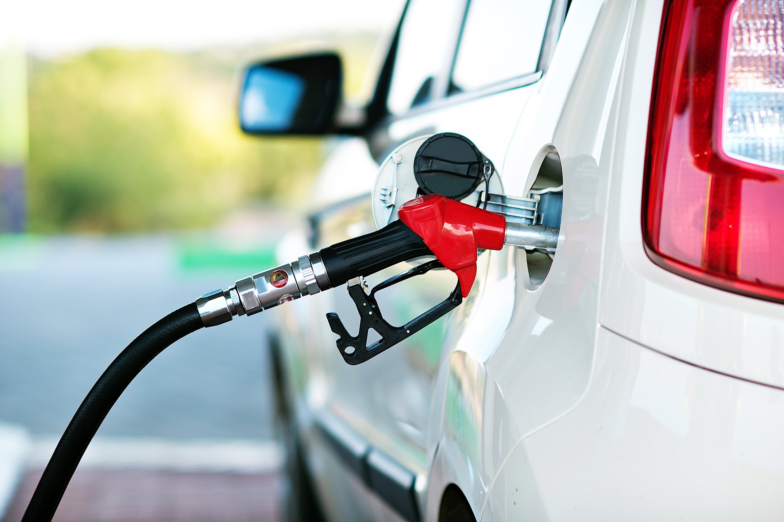 car getting filled with gas pump at gas station
