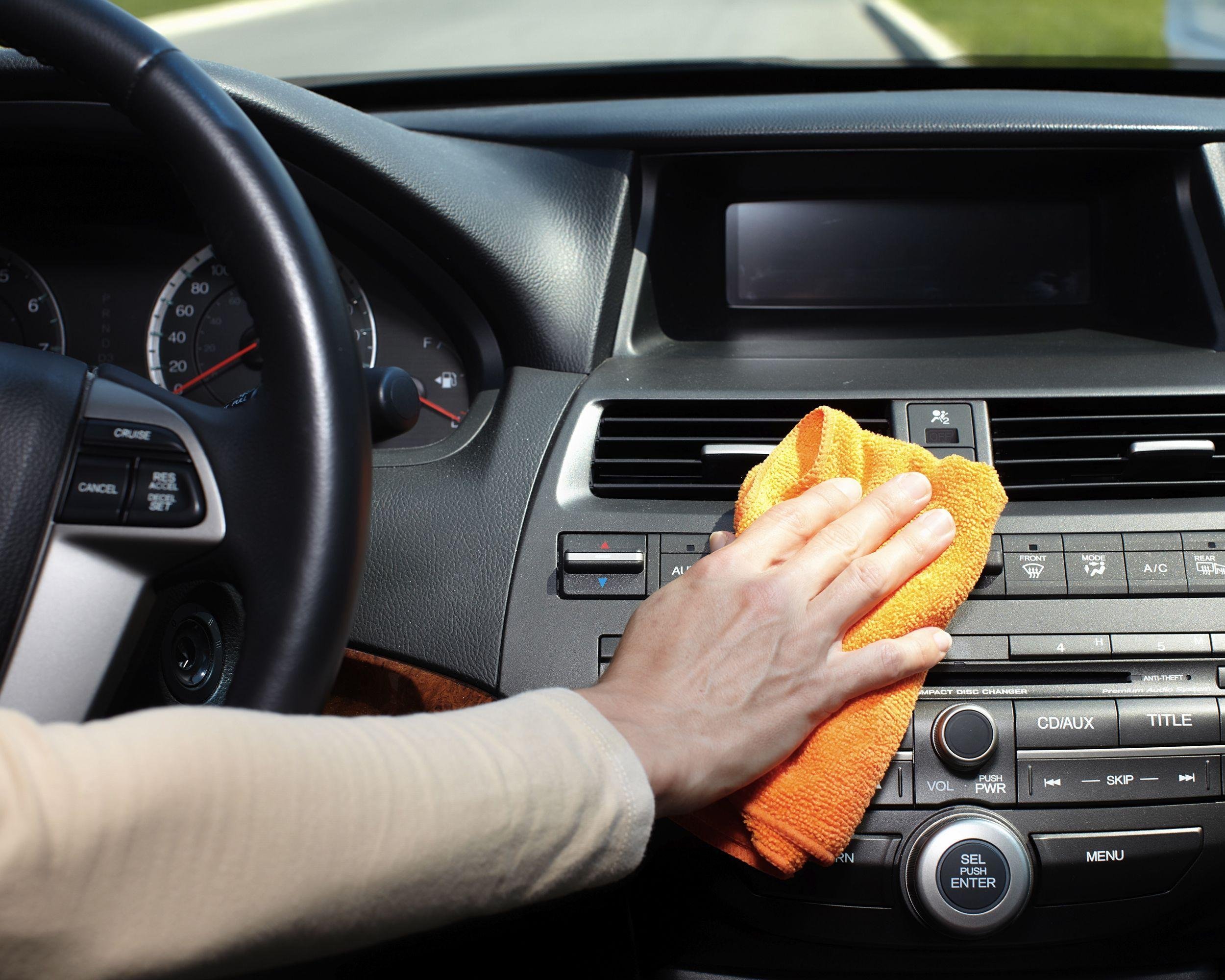 hand with microfiber cloth cleaning car