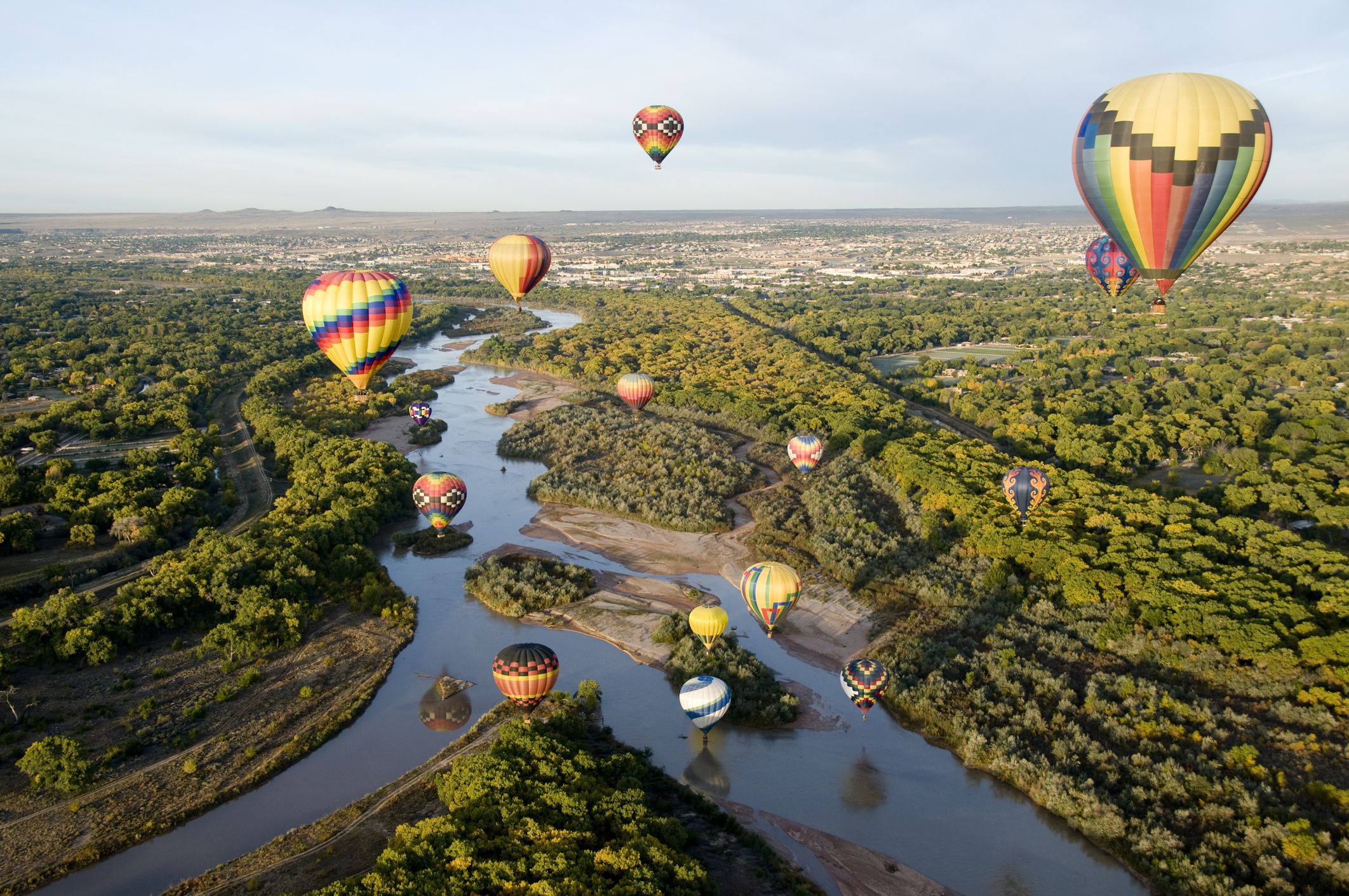 Aerial of hot air balloons drifting over the Rio Grande river in Albuquerque, New Mexico