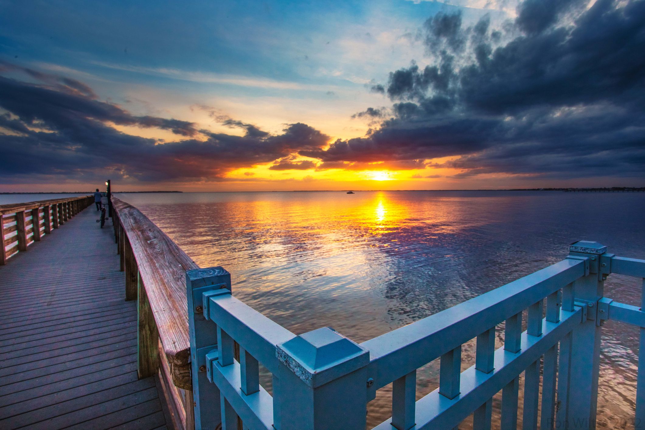 Bayshore Live Oak Park, Port Charlotte, Punta Gorda, Florida during sunset with porch in the foreground with pier and ocean on the background