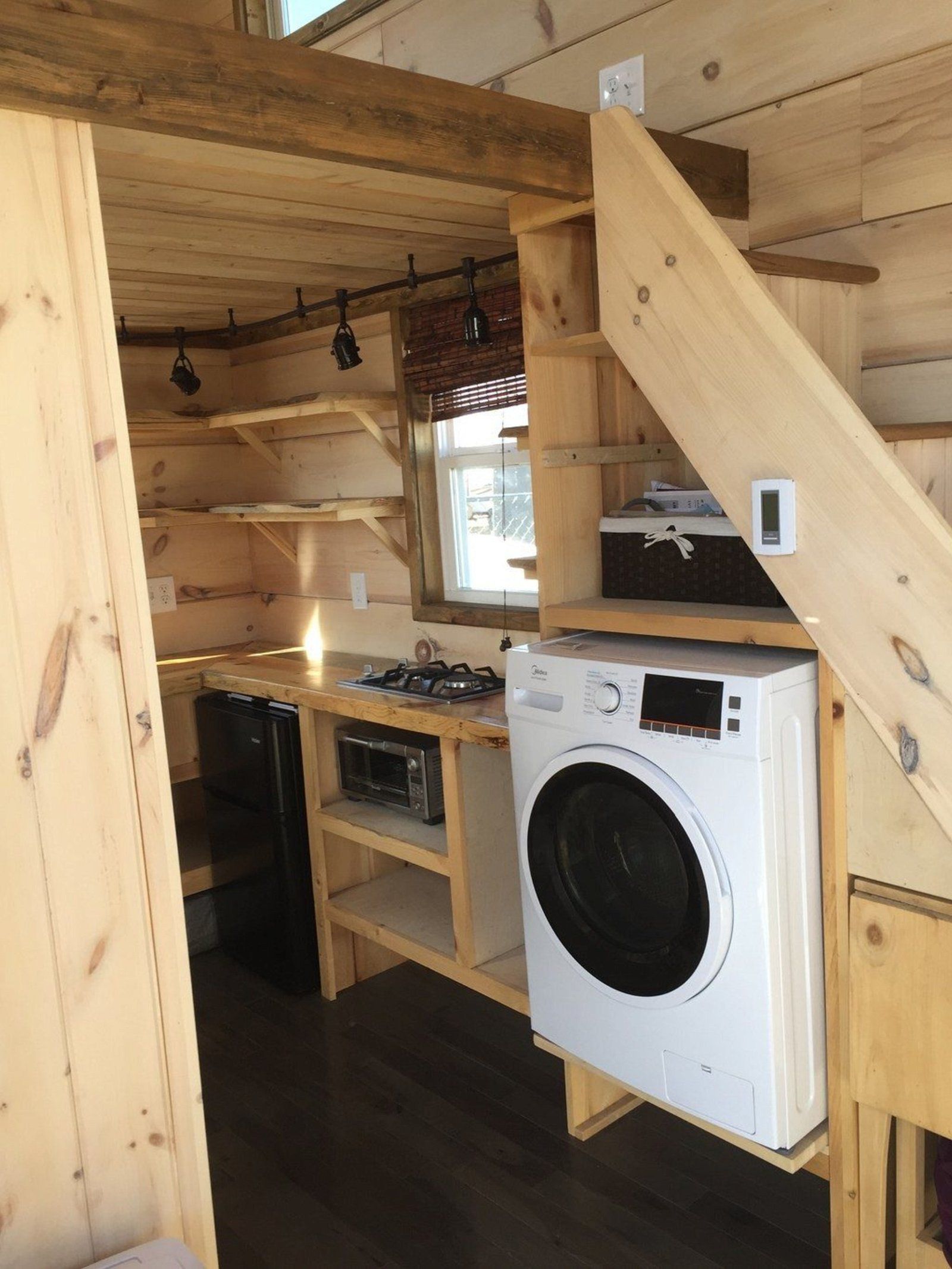 Rustic wooden interior kitchen and loft stairs in Cozy Tiny Cabin, Colorado Springs, Colorado, bare and minimalistic