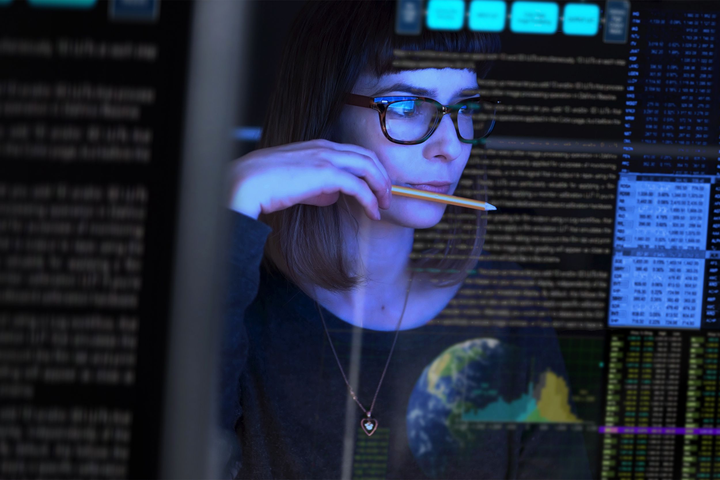 Analyst looking at data on a screen