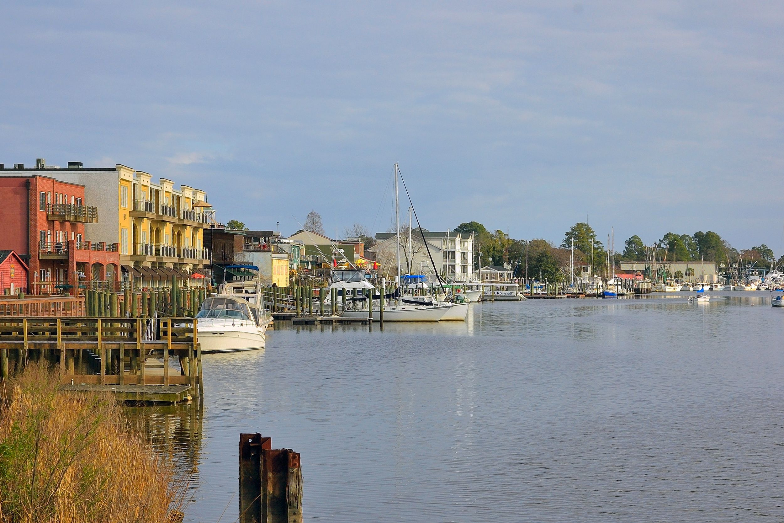 Georgetown, South Carolina Harbor during winter, with colorful buildings with fishing boats, sailboats, and recreational boats