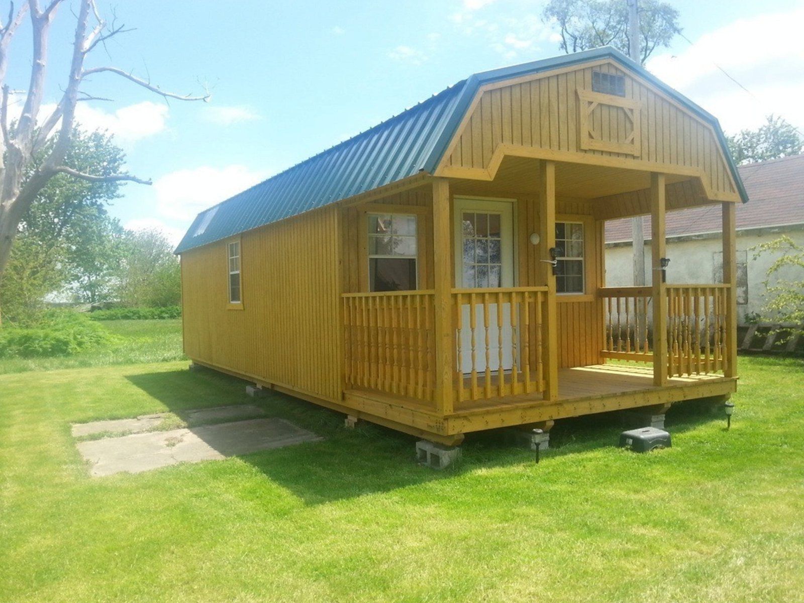 Front and side exterior of Skylights and Lofts Cabin, Fithian, Illinois, on grass, on a sunny day