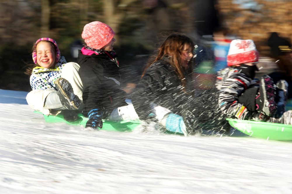 Sledding in Central Park, Manhattan, New York, USA.