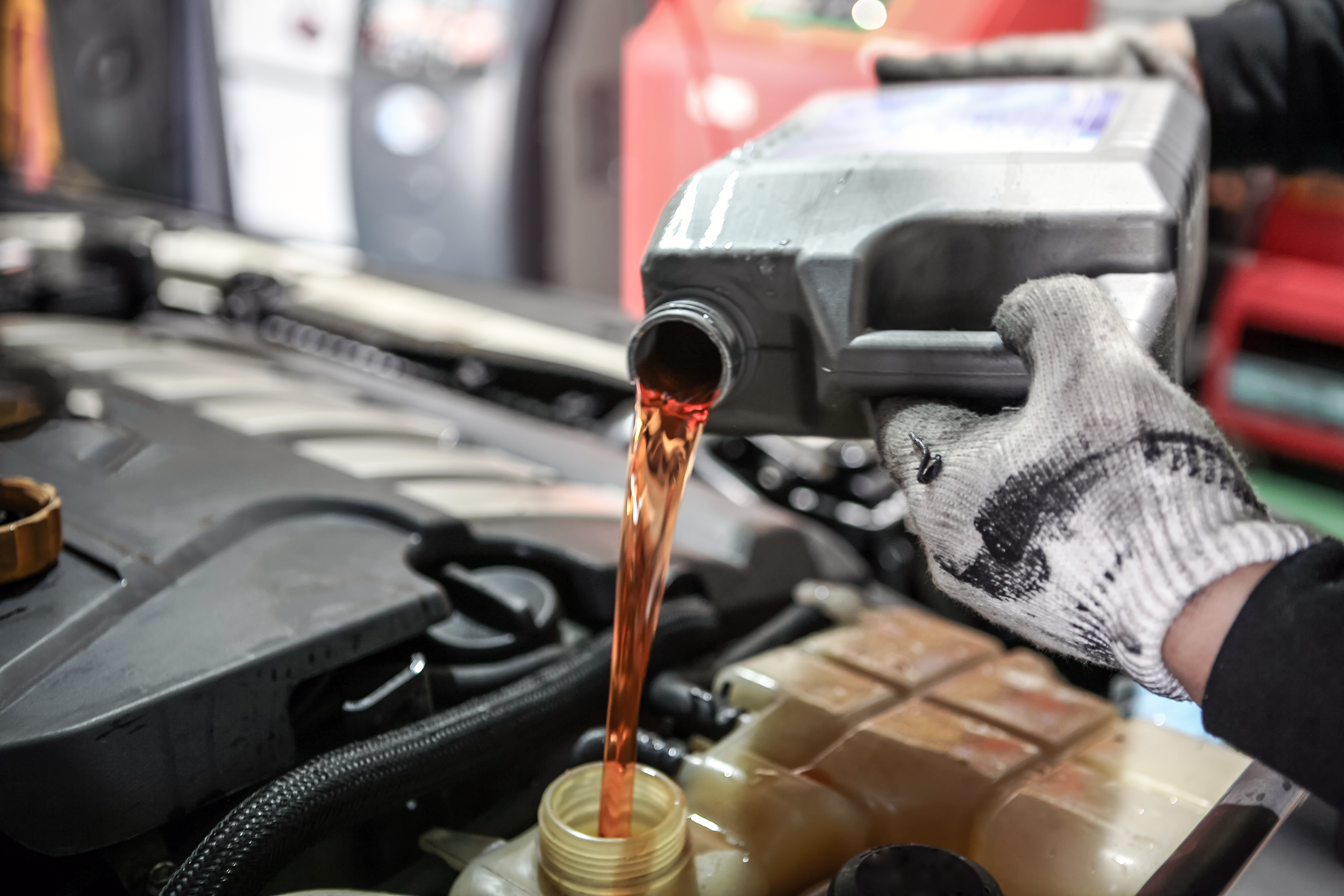 Pouring synthetic oil into a car