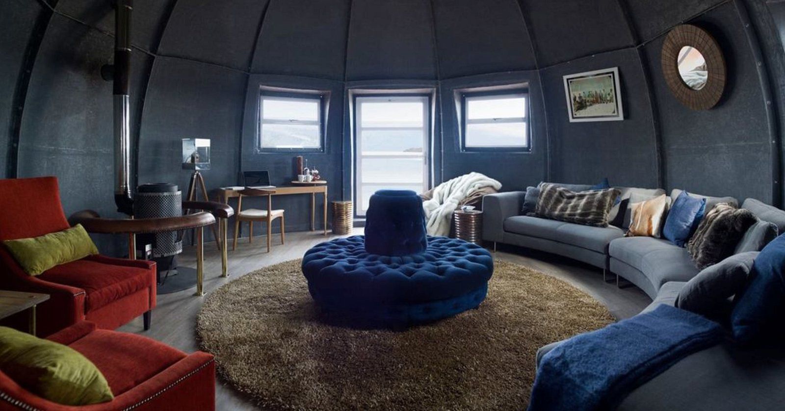 Round interior room of The Universal Dome, Kansas City, Missouri, dark grey walls, furnished