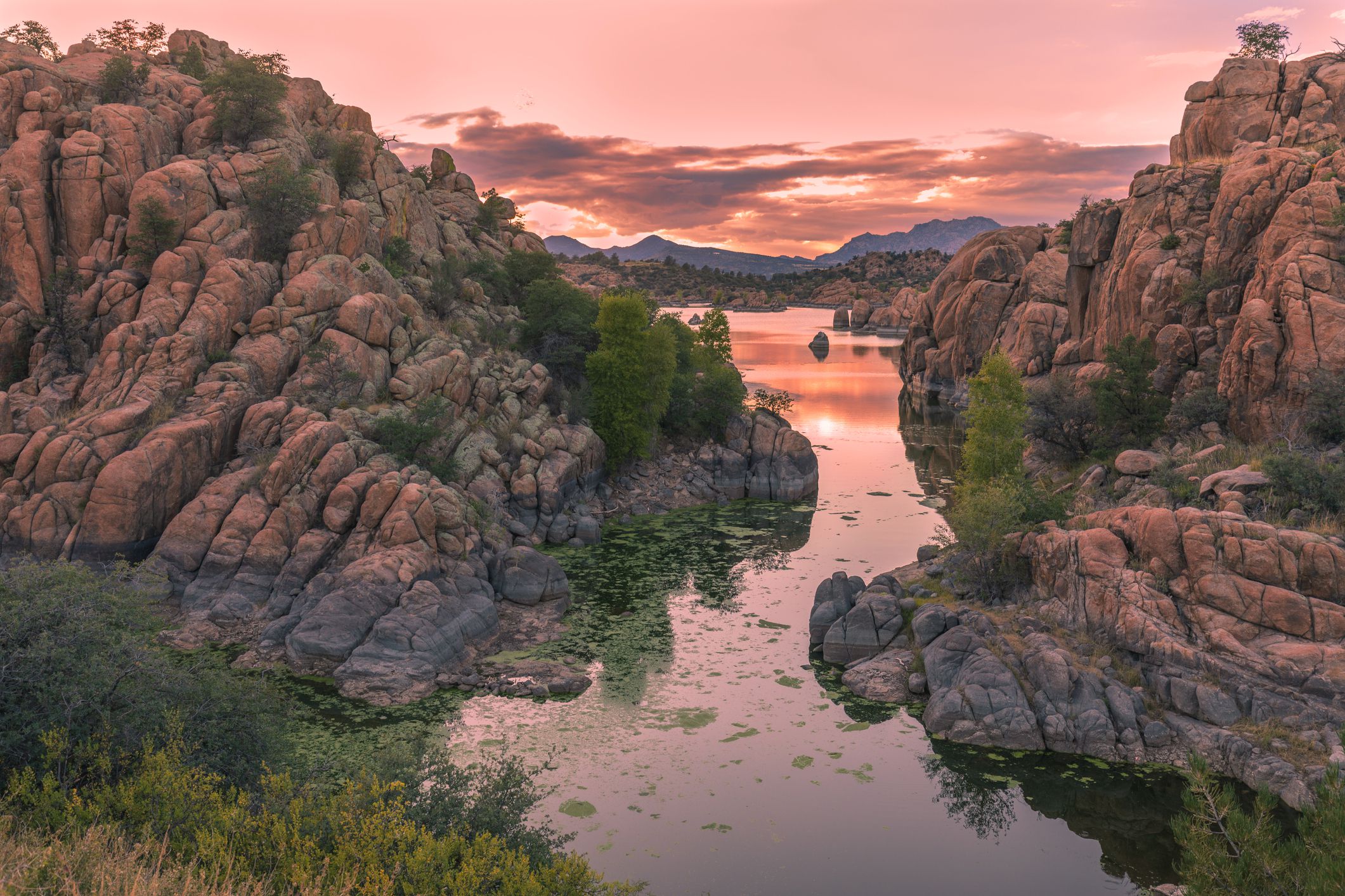 Scenic Watson Lake in Prescott, Arizona during sunset with magenta pinks and reds
