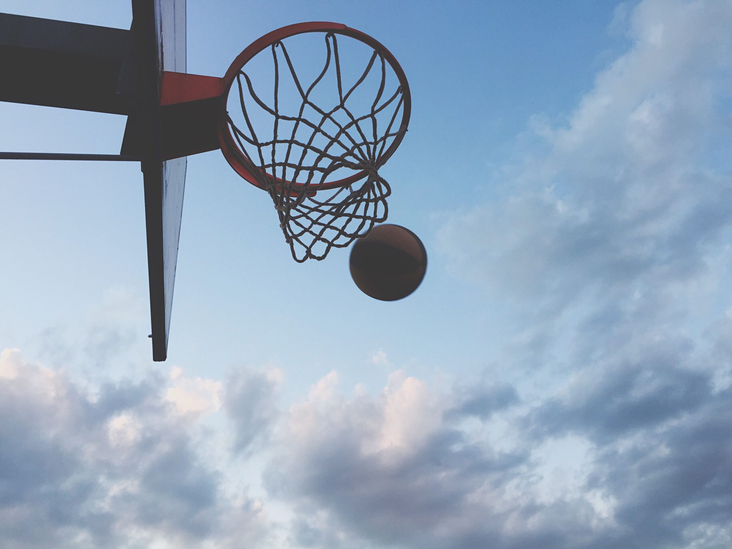 Win. Team sport. Shooting a ball through a hoop.