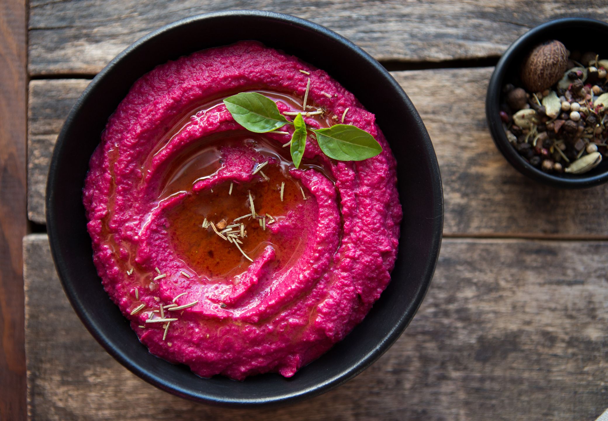 colored hummus, classic hummus, beet hummus, hummus on a dark rustic background. Top view, flat lay. Clean eating, dieting, vegetarian party food.