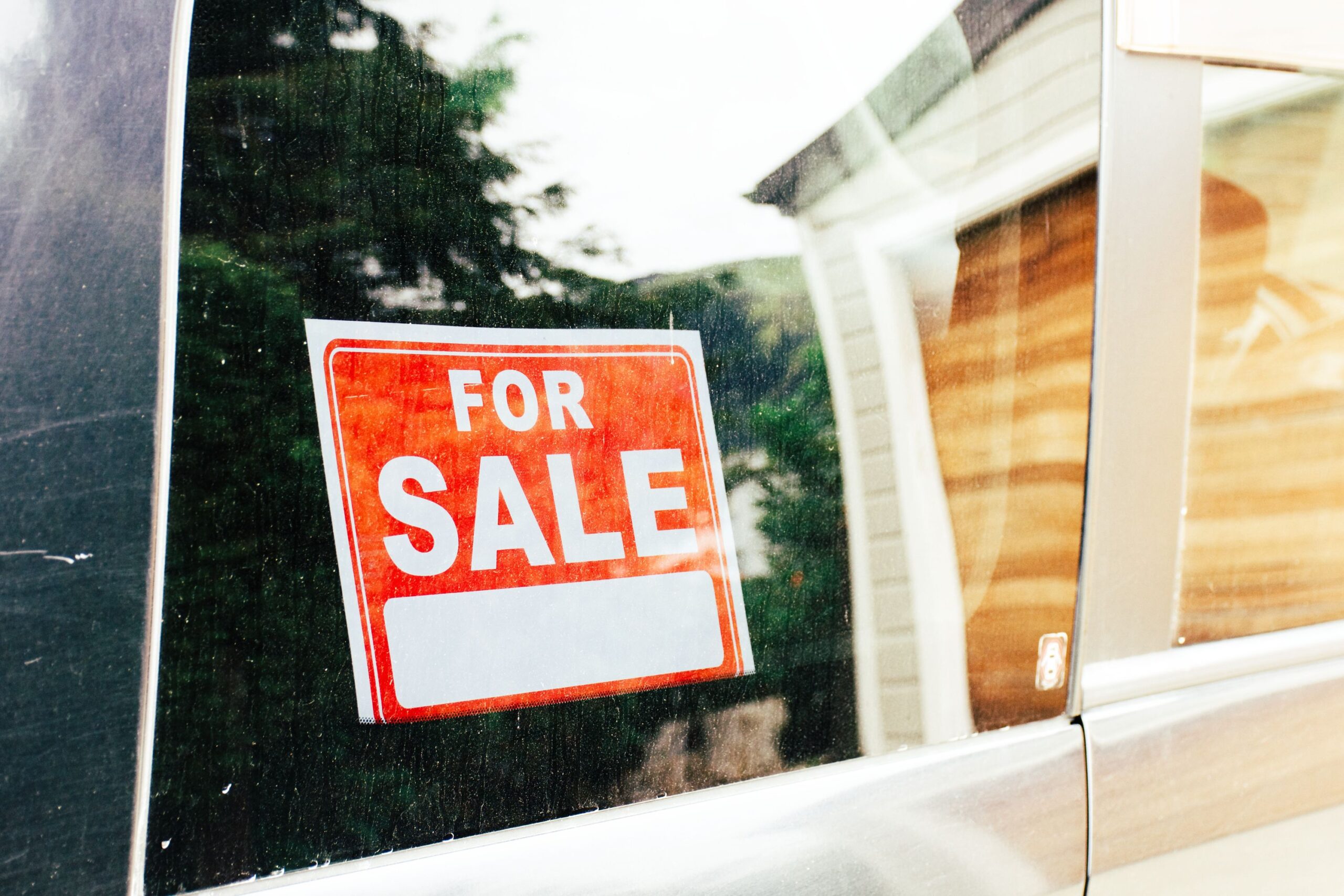 A For Sale sign in a car window.