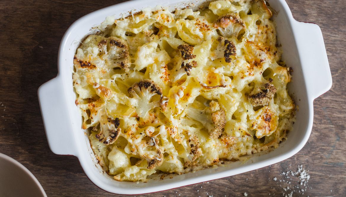 Cauliflower mac and cheese on the brown wooden table, top view