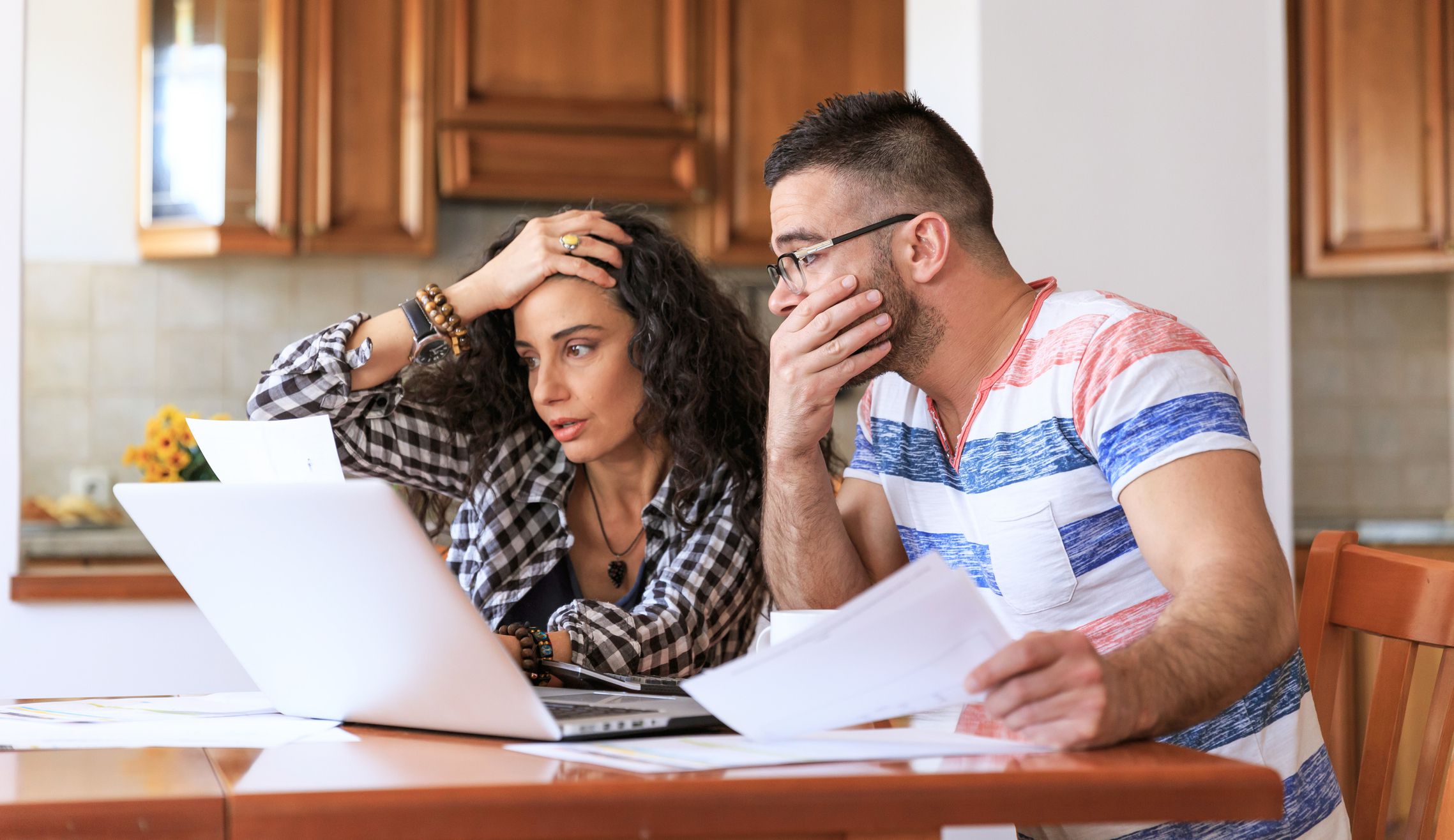 Young woman sitting at home and making home finances, with casual clothes.