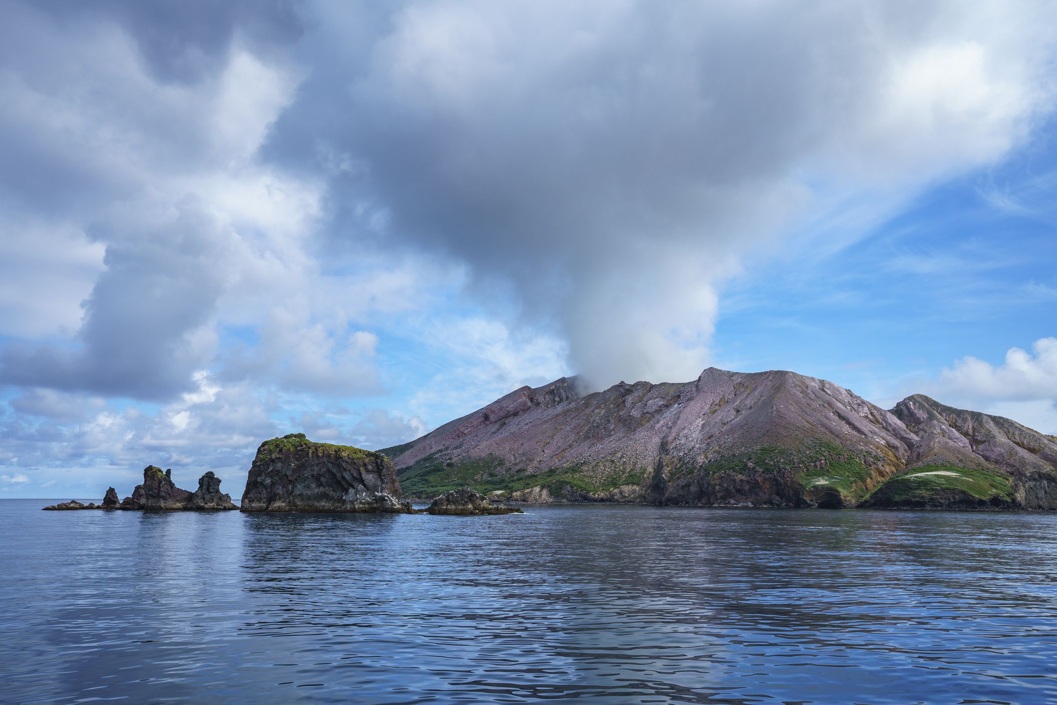 view from the ocean. smoke over volcano,white island,bay of plenty,new zealand