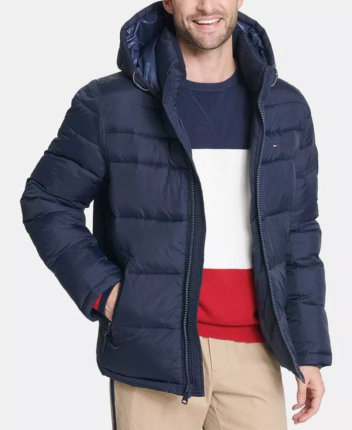 man wearing a navy blue tommy hilfiger puffer coat