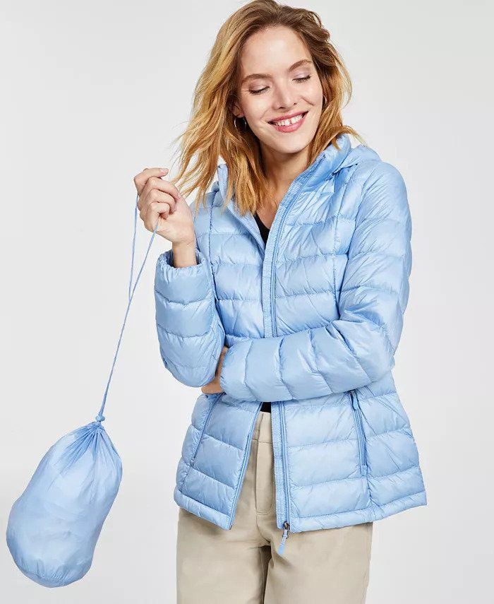 woman wearing a powder blue puffer coat