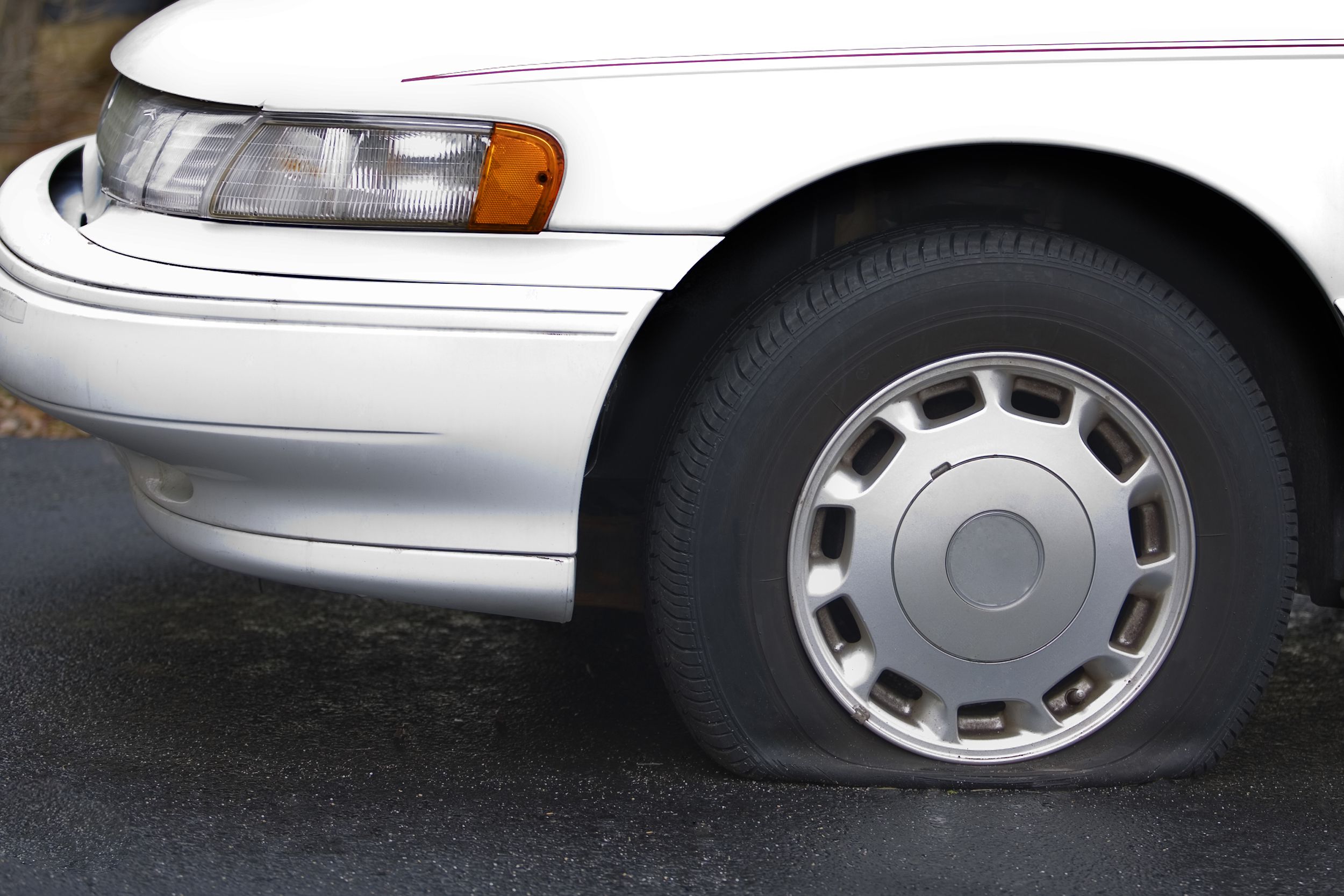 flat tire on white car