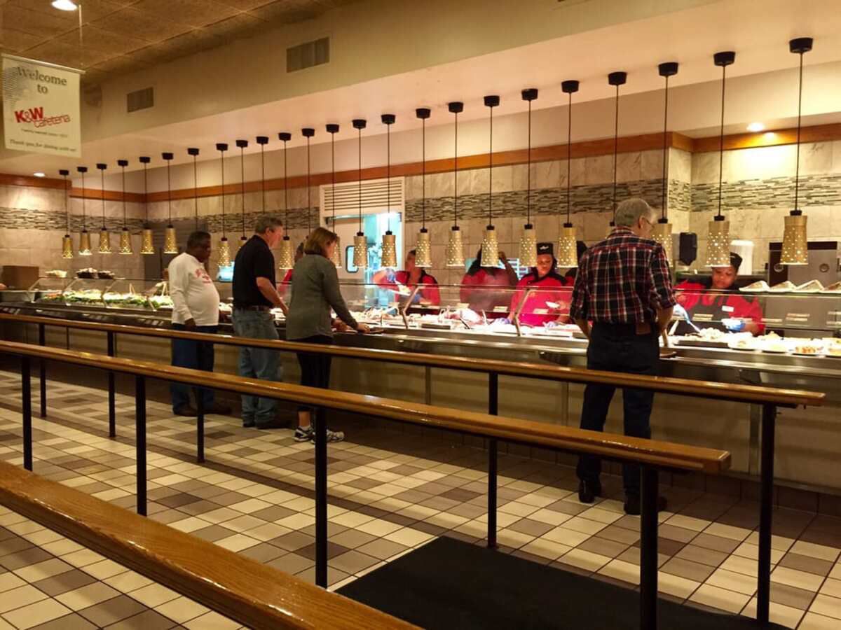 Buffet food area line, K&W Cafeteria, Raleigh, North Carolina, a few people being served food by workers behind the buffet counter, clean interior, well-lit