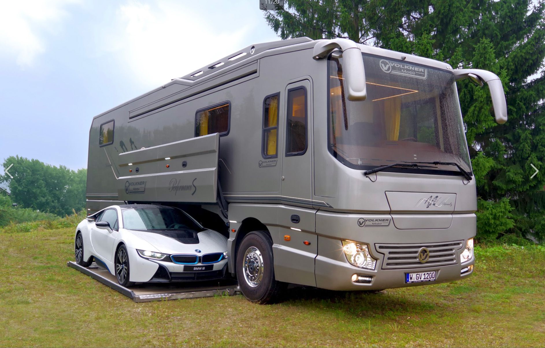 Exterior of Volkner Performance S with a white luxury car in the compartment with the door open, outside on lawn on a sunny day