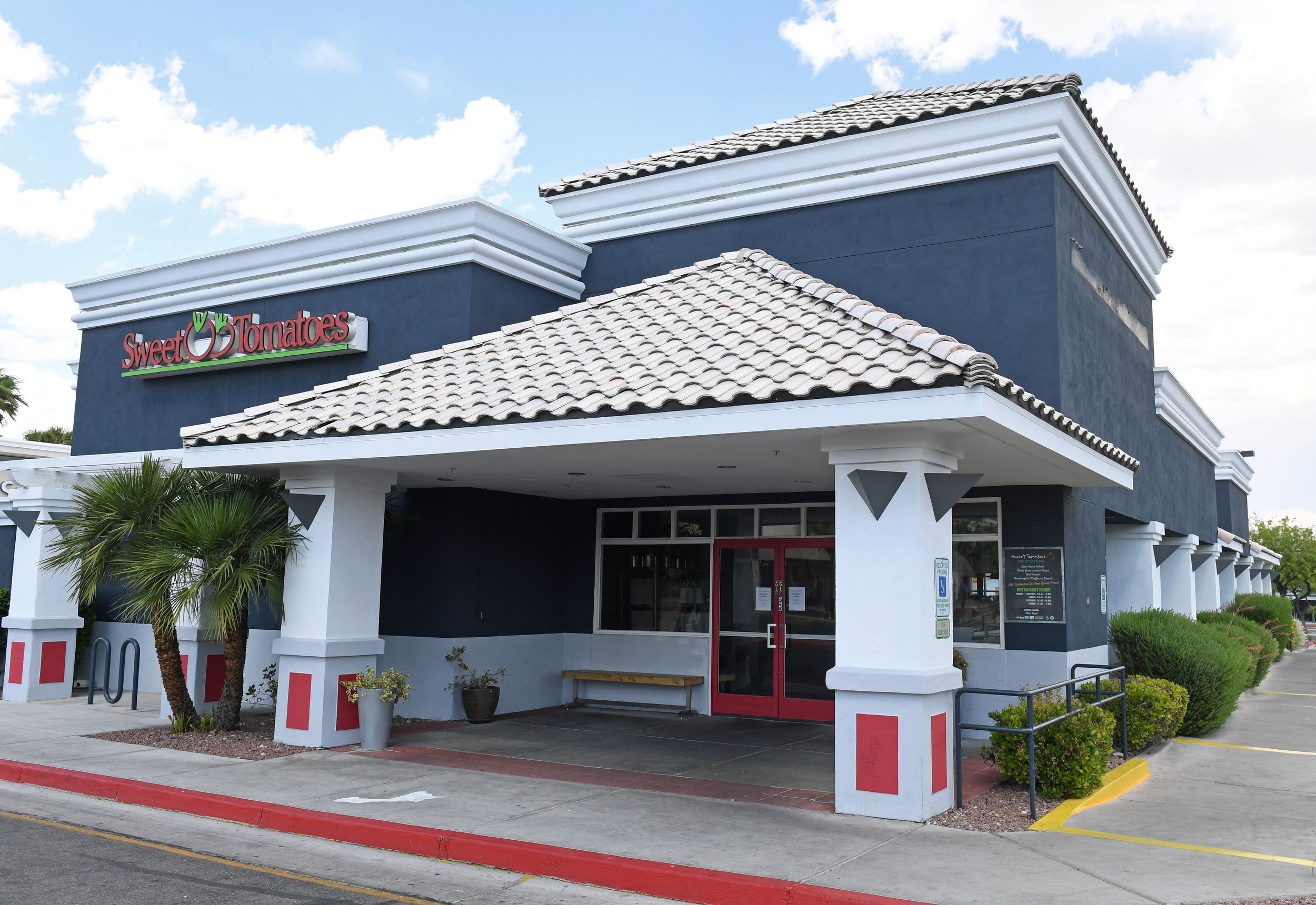 Front exterior of Sweet Tomatoes, Las Vegas, closed but clean, surrounded by sidewalk, on a sunny day