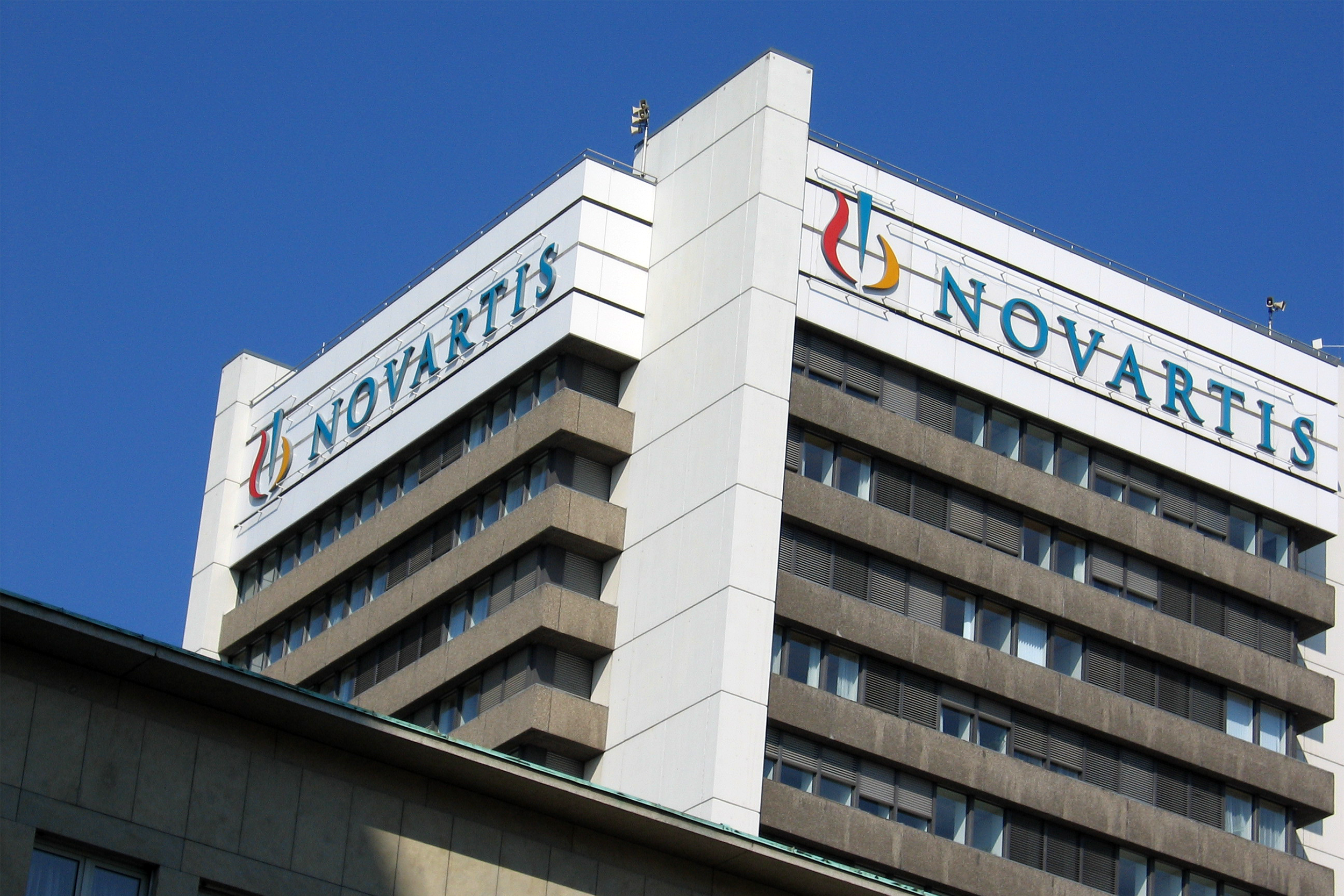 Front high-rise top of Novartis headquarters building, Basel, Switzerland, a clear blue sky in the background