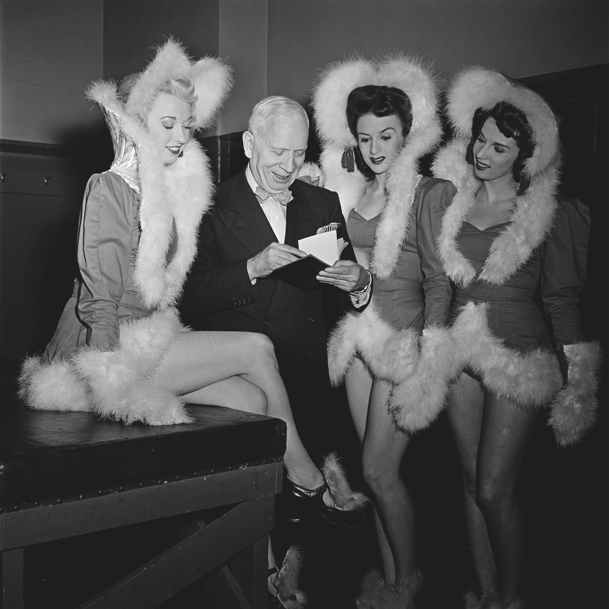 Members of The Rockettes precision dance company with a fan backstage at the Radio City Music Hall
