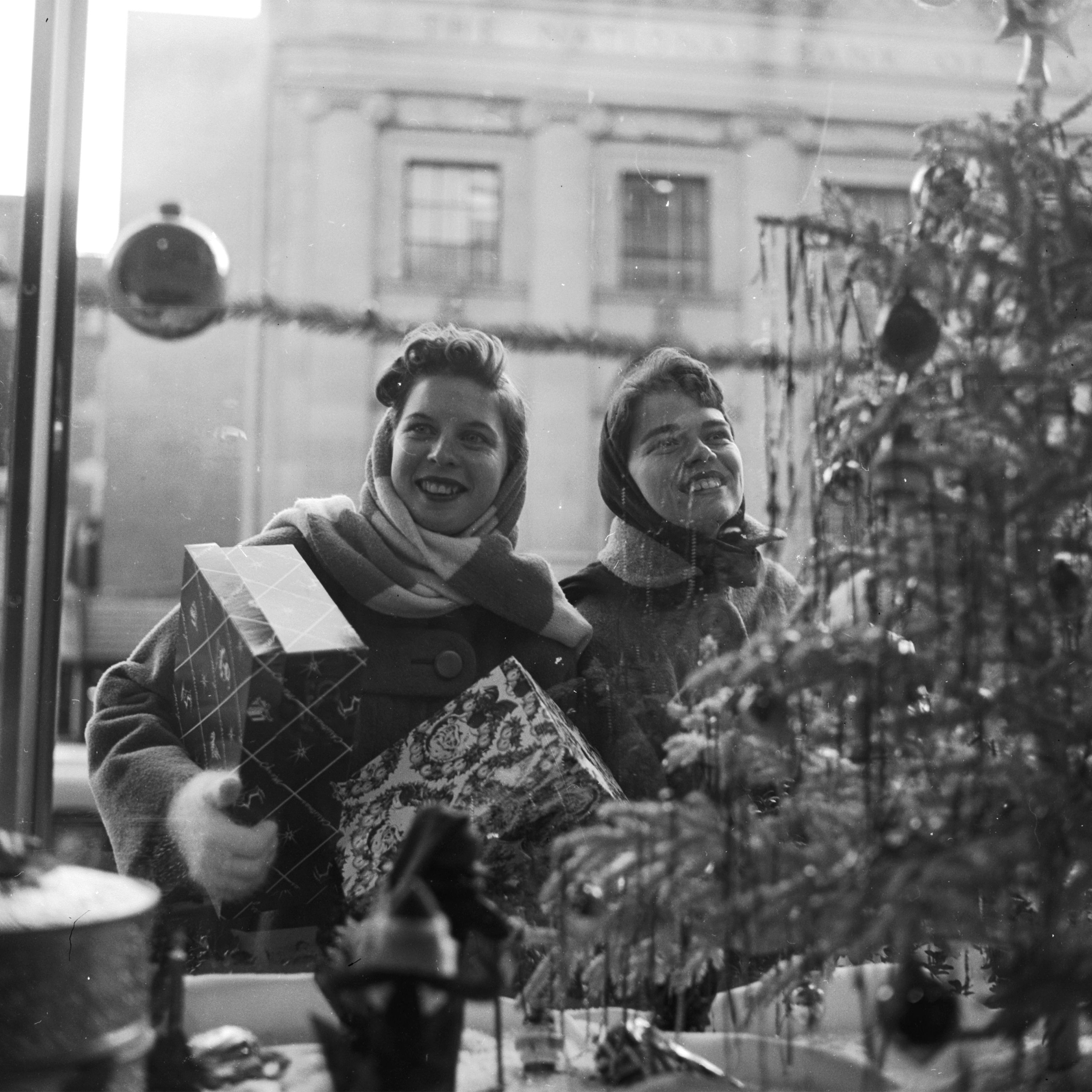 Happy Christmas shoppers happily gaze at the window displays of the shops of Washington DC.