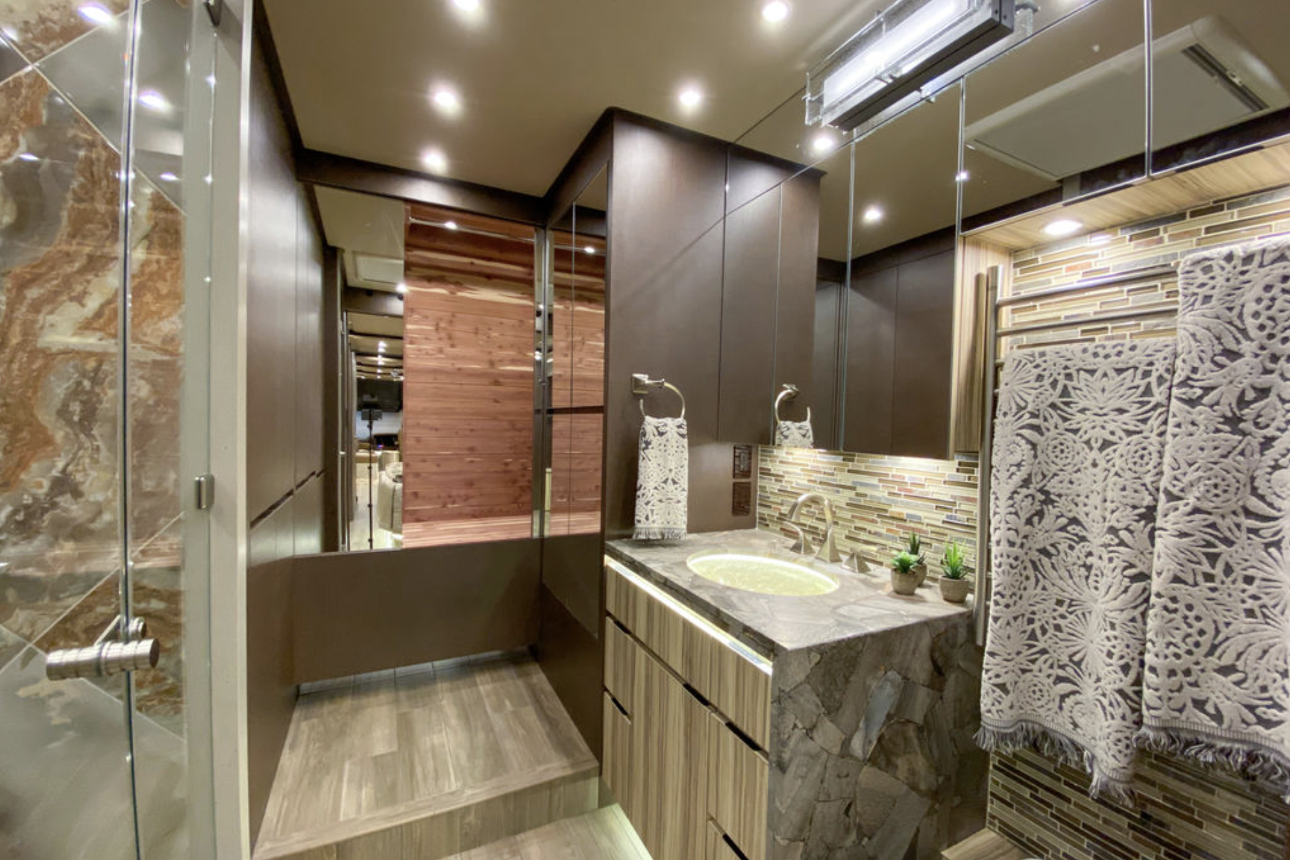 Interior of Newell Coach p50, luxurious deluxe bathroom with shower and sauna, stone accents