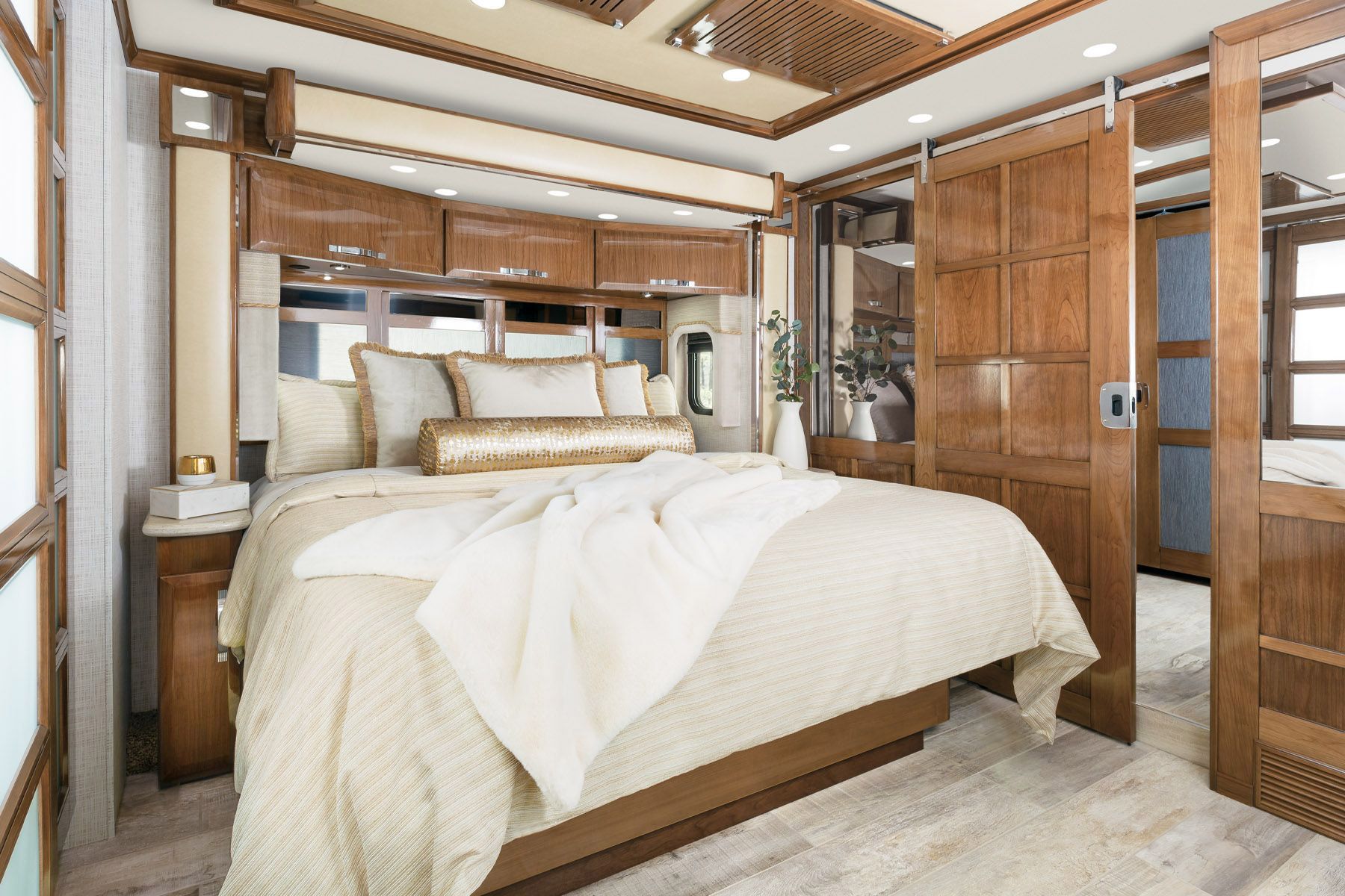 Interior of Newmar King Aire, bedroom with luxurious bed and accents