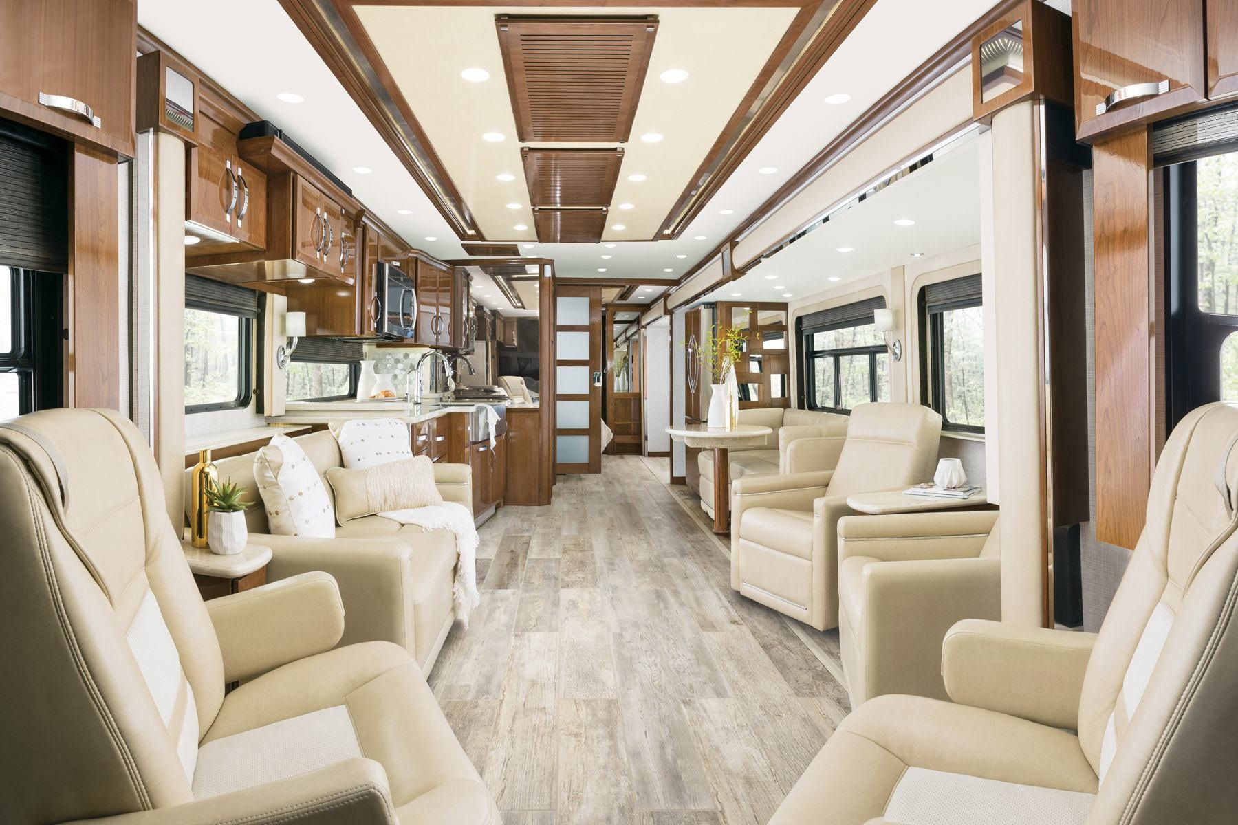 Interior of Newmar King Aire, seating area with beige coloring and brown wooden accents