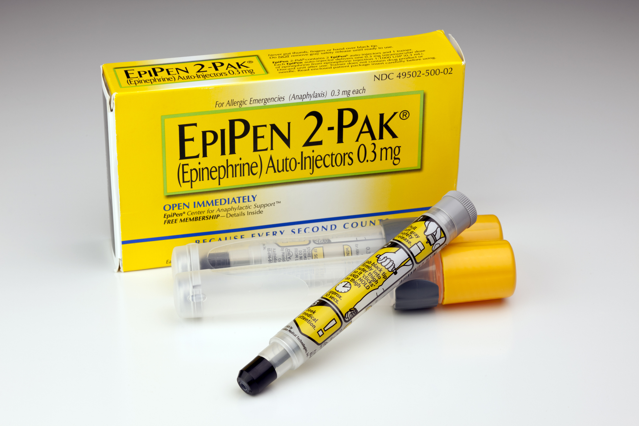 Prescription EpiPen 2-Pak yellow box with two EpiPens outside of it, on a light grey table and background