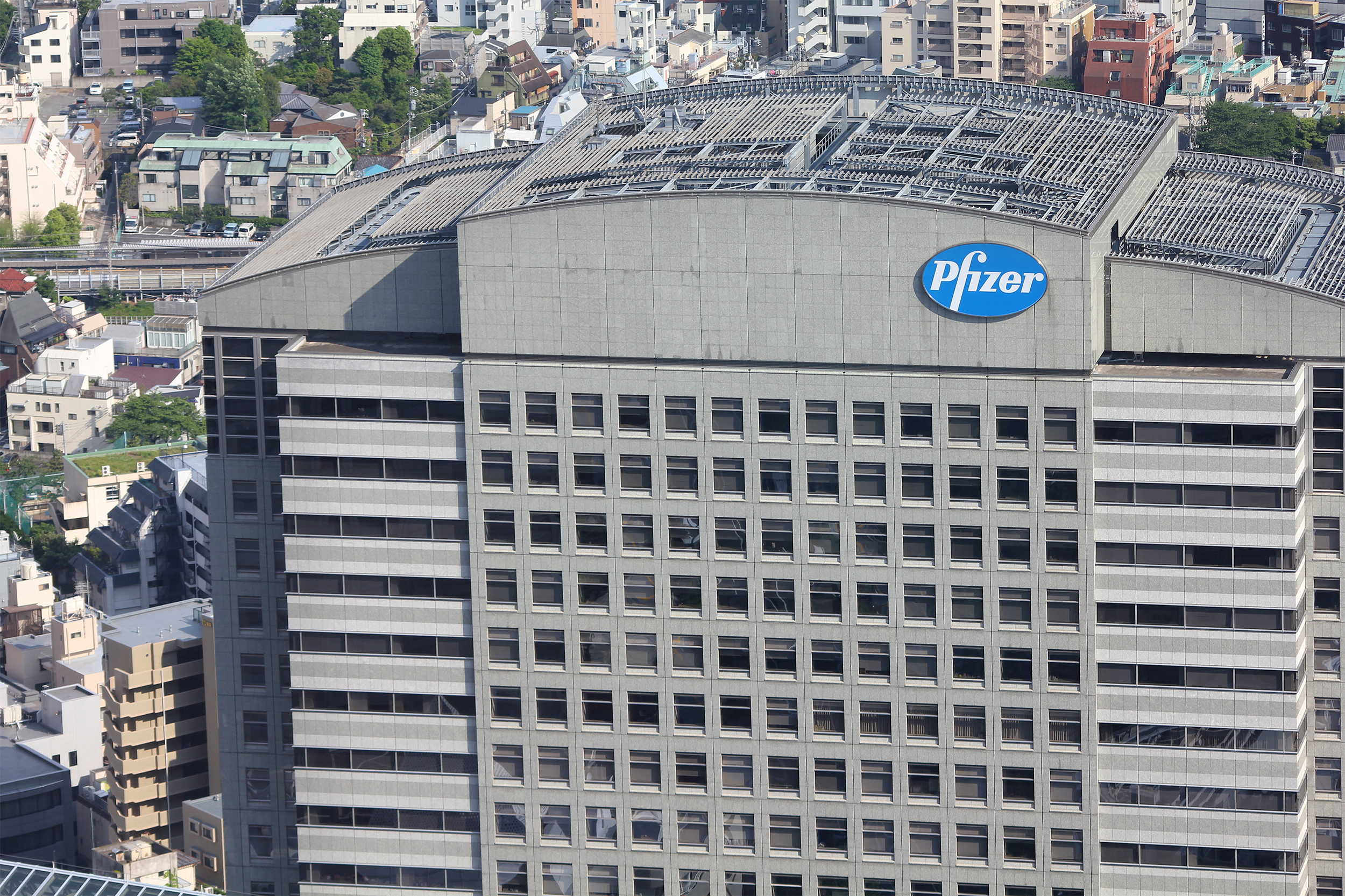 Top of high-rise Pfizer building, Tokyo, several condo buildings on the left and top